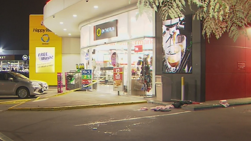The man was found with life-threatening injuries at a service station.