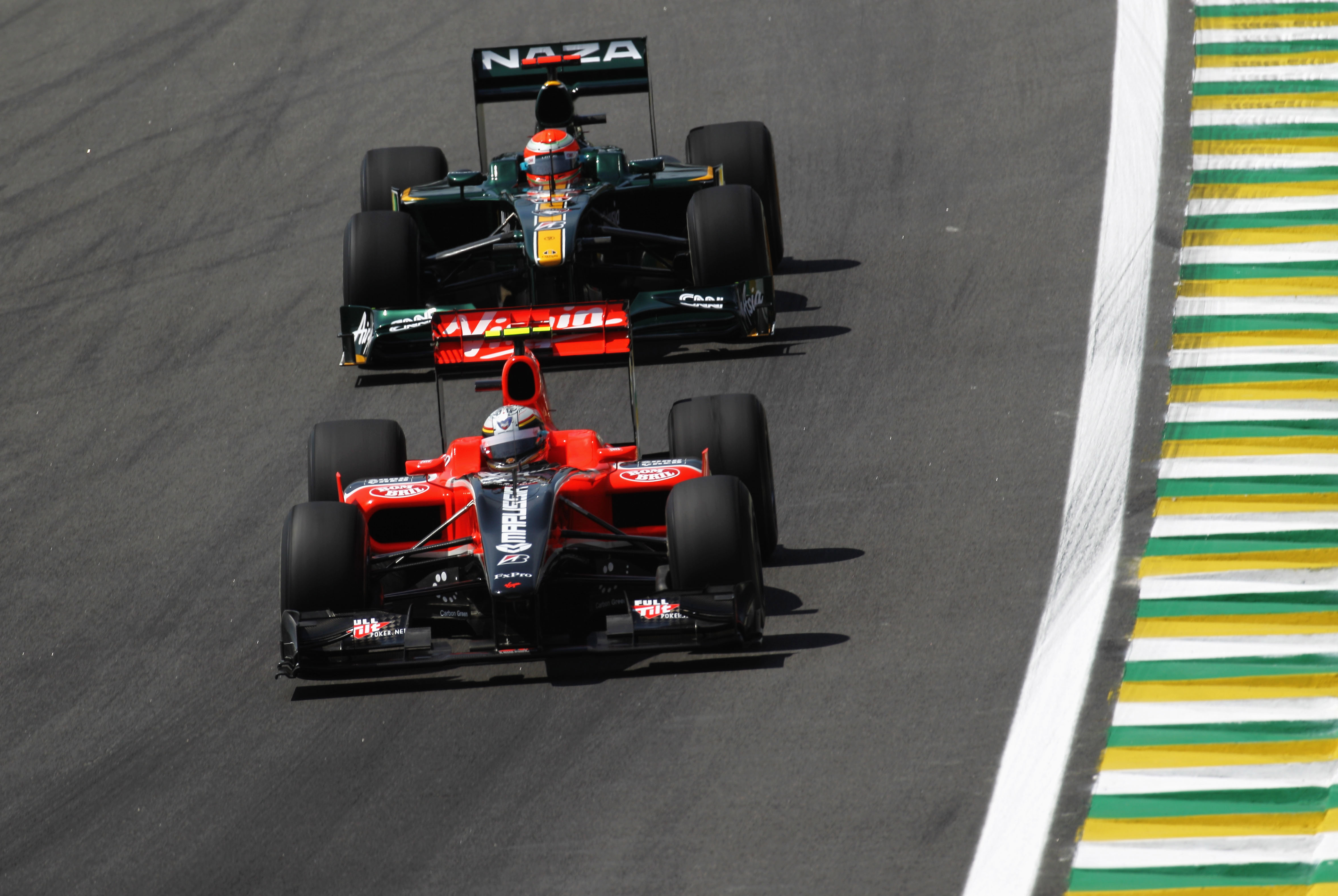 A Virgin Marussia and a Lotus during practice the 2010 Brazilian Grand Prix weekend.