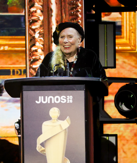 HAMILTON, ONTARIO - MARCH 29: Joni Mitchell accepts the Lifetime Achievement award onstage during the 2026 JUNO Awards at TD Coliseum on March 29, 2026 in Hamilton, Ontario. (Photo by Cindy Ord/Getty Images)