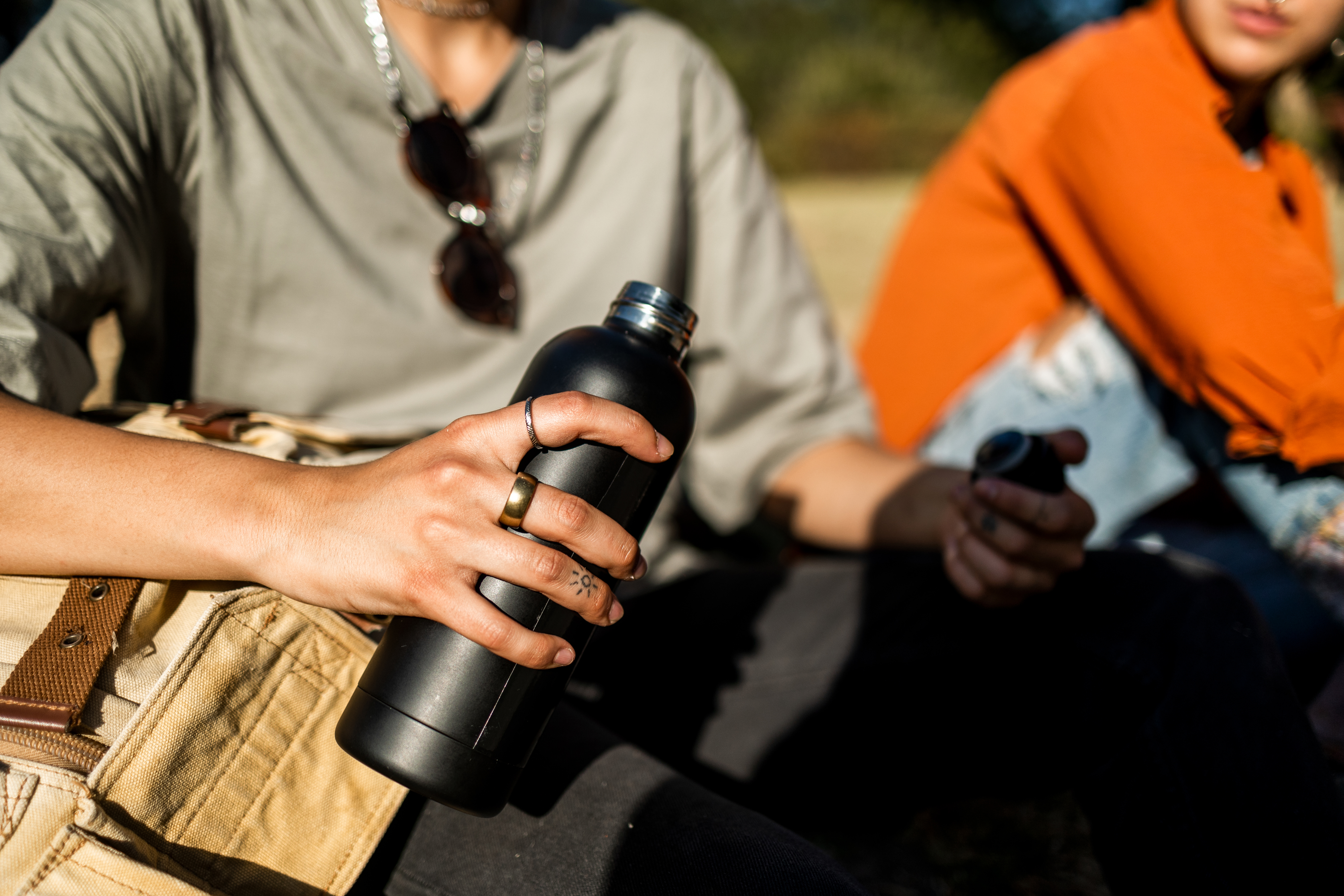 Close up of human hand holding reusable water bottle