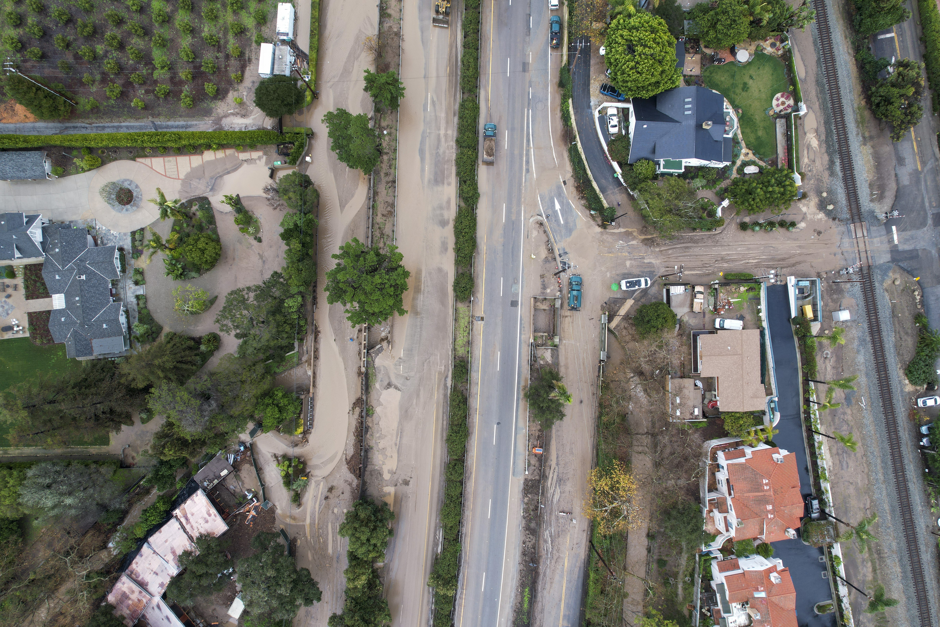 In an aerial view, a flooded area by the overflowing San Ysidro creek on Jameson Lane is seen near the closed Highway 101 in Montecito, Calif., Tuesday, Jan. 10, 2023.  