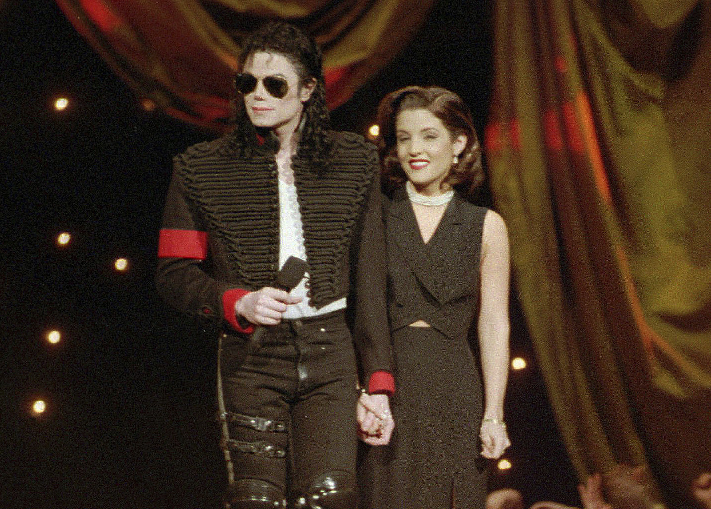 Michael Jackson and Lisa Marie Presley-Jackson acknowledge applause from the audience after coming out onstage to open the 11th annual MTV Video Music Awards at New York's Radio City Music Hall, Sept. 8, 1994