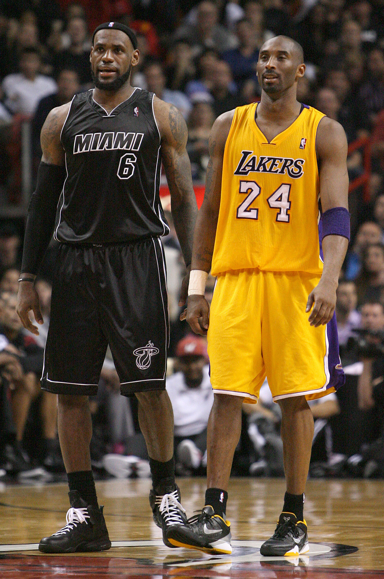 In this 2012 photo, Miami Heat's LeBron James and Los Angeles Lakers' Kobe Bryant look on during the third quarter of an NBA basketball game in Miami.