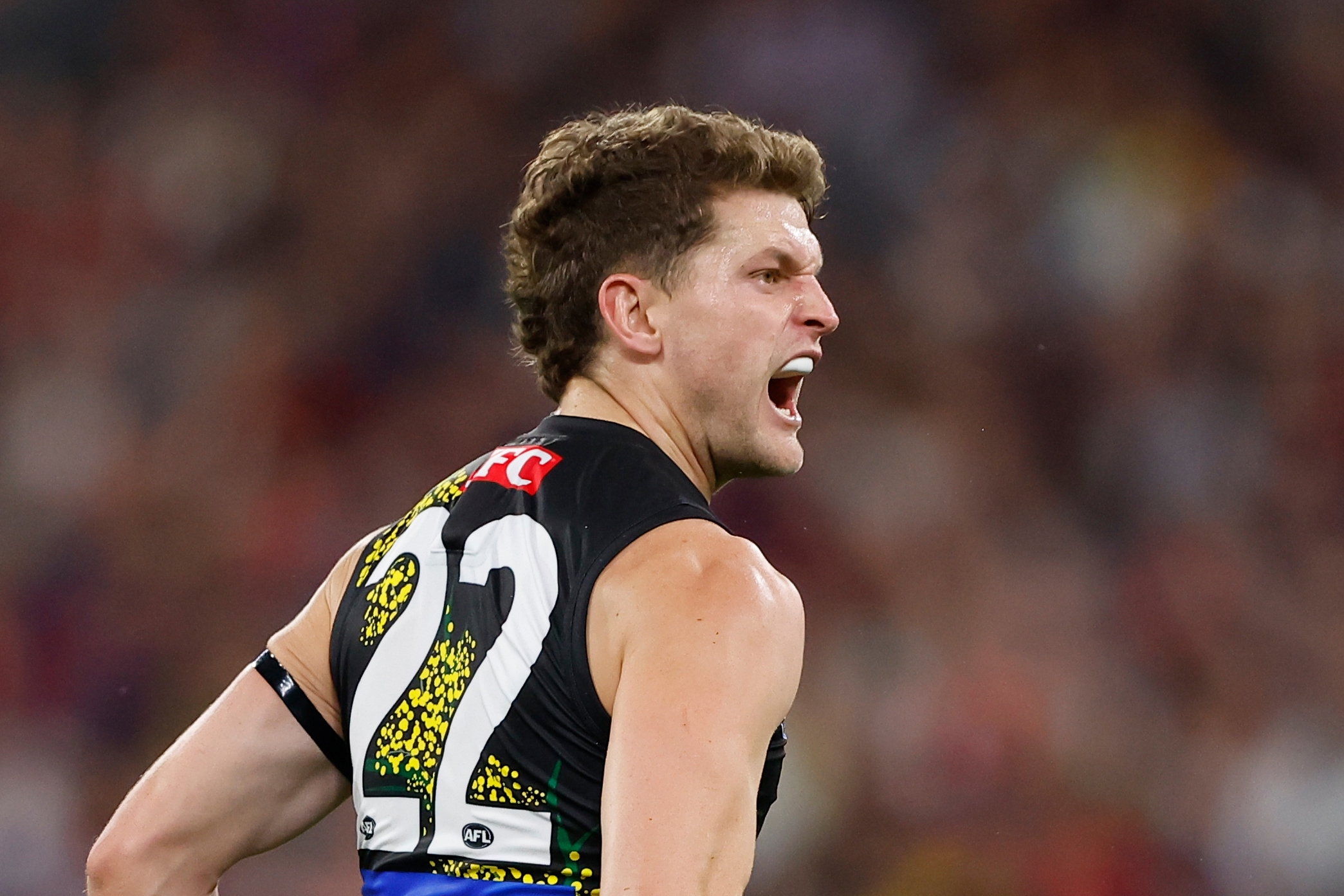 Jacob Hopper of the Tigers kicks a goal during the 2023 AFL round six match between the Melbourne Demons and the Richmond Tigers.