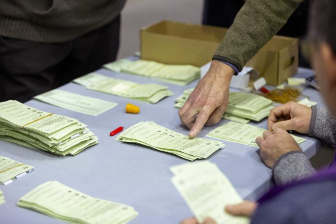 Scrutineers oversee AEC staff conducting a recount of votes for the federal electorate of Bradfield where there is a tight contest between Liberal candidate Gisele Kapterian and Independent Nicolette Boele.