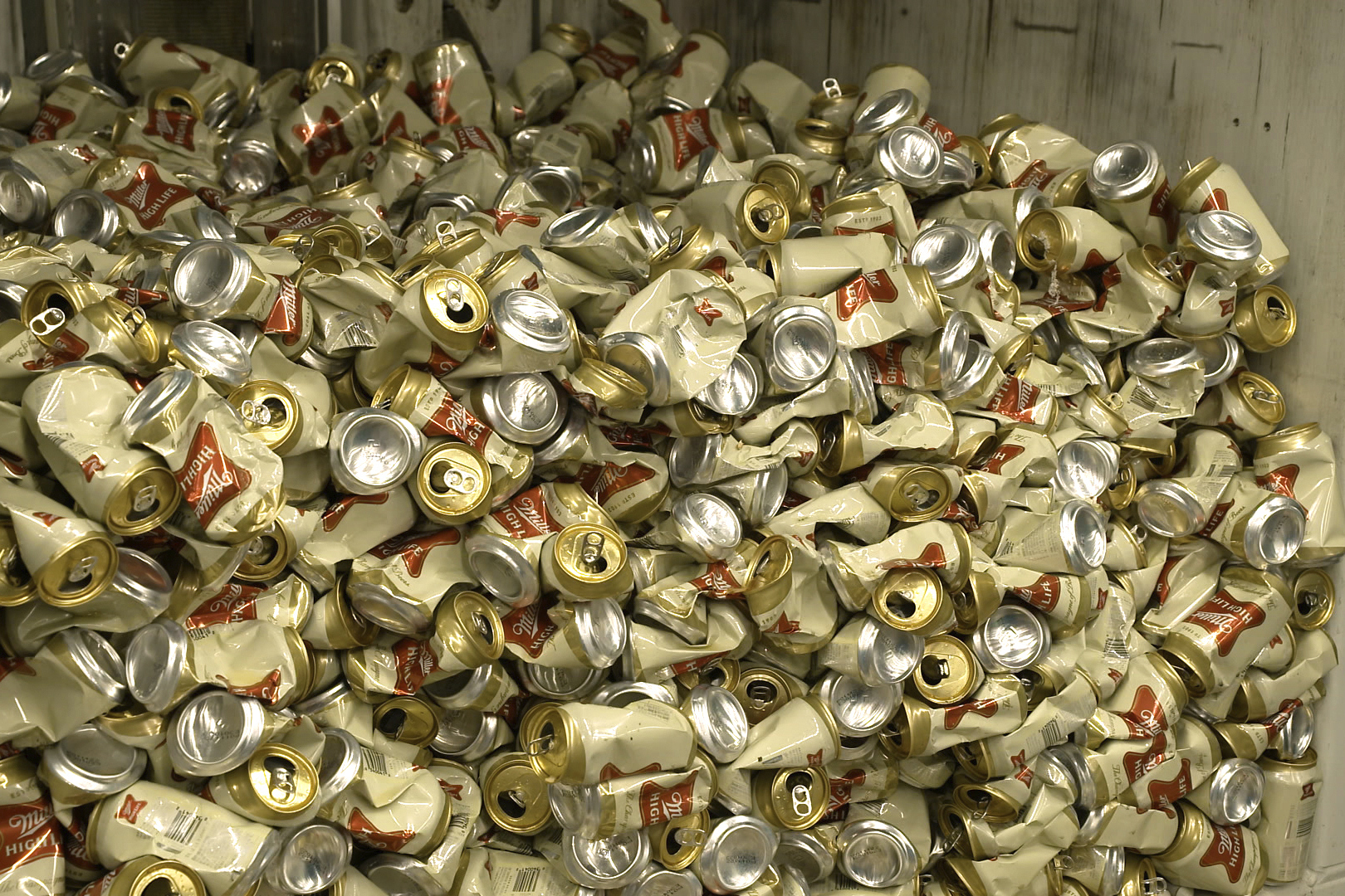 Cans of Miller High Life beer sit in a container after being crushed at the Westlandia plant in Ypres, Belgium, Monday, April 17, 2023. 