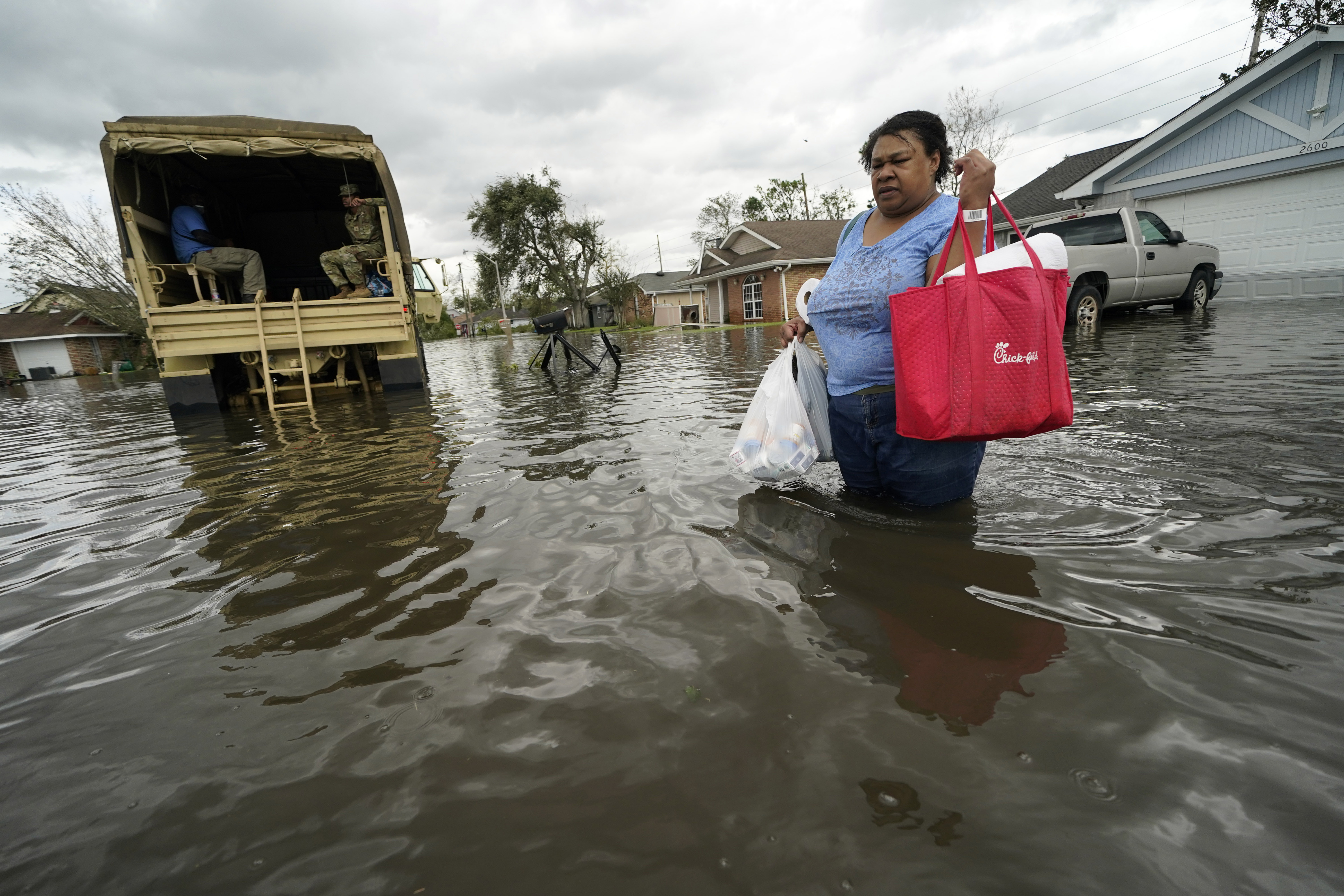 Jerilyn Collins returns to her destroyed home with the assistance of a Louisiana National Guard high-water vehicle to retrieve medicine for herself and her father, and a few possessions, after she evacuated from rising floodwater in the aftermath of Hurricane Ida in LaPlace, Louisiana.
