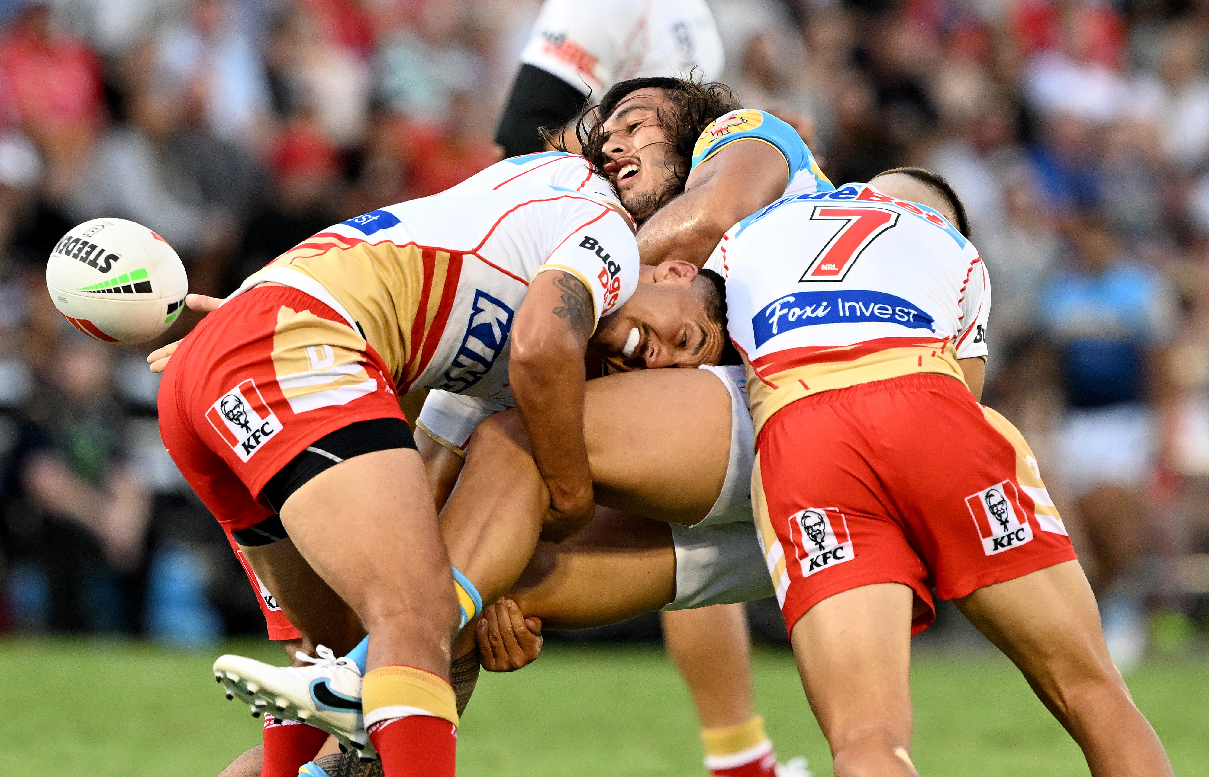 Tino Fa'asuamaleaui of the Titans offloads during the NRL Trial Match between the Dolphins and the Gold Coast Titans at Kayo Stadium on February 19, 2023 in Brisbane, Australia. (Photo by Bradley Kanaris/Getty Images)