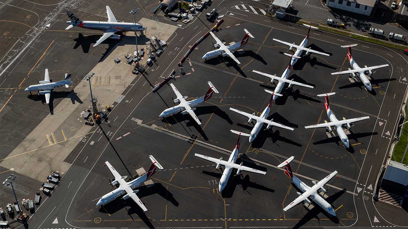 Qantas planes are parked on the tarmac at Sydney Airport.