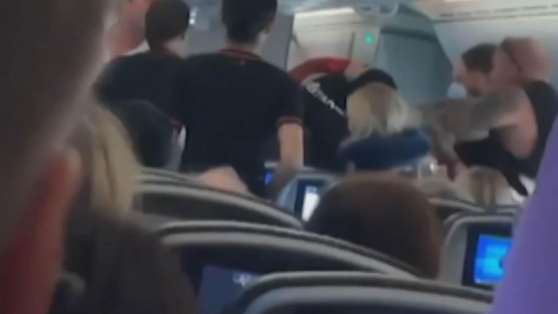 Fight breaks out on flight from Bali to Brisbane.