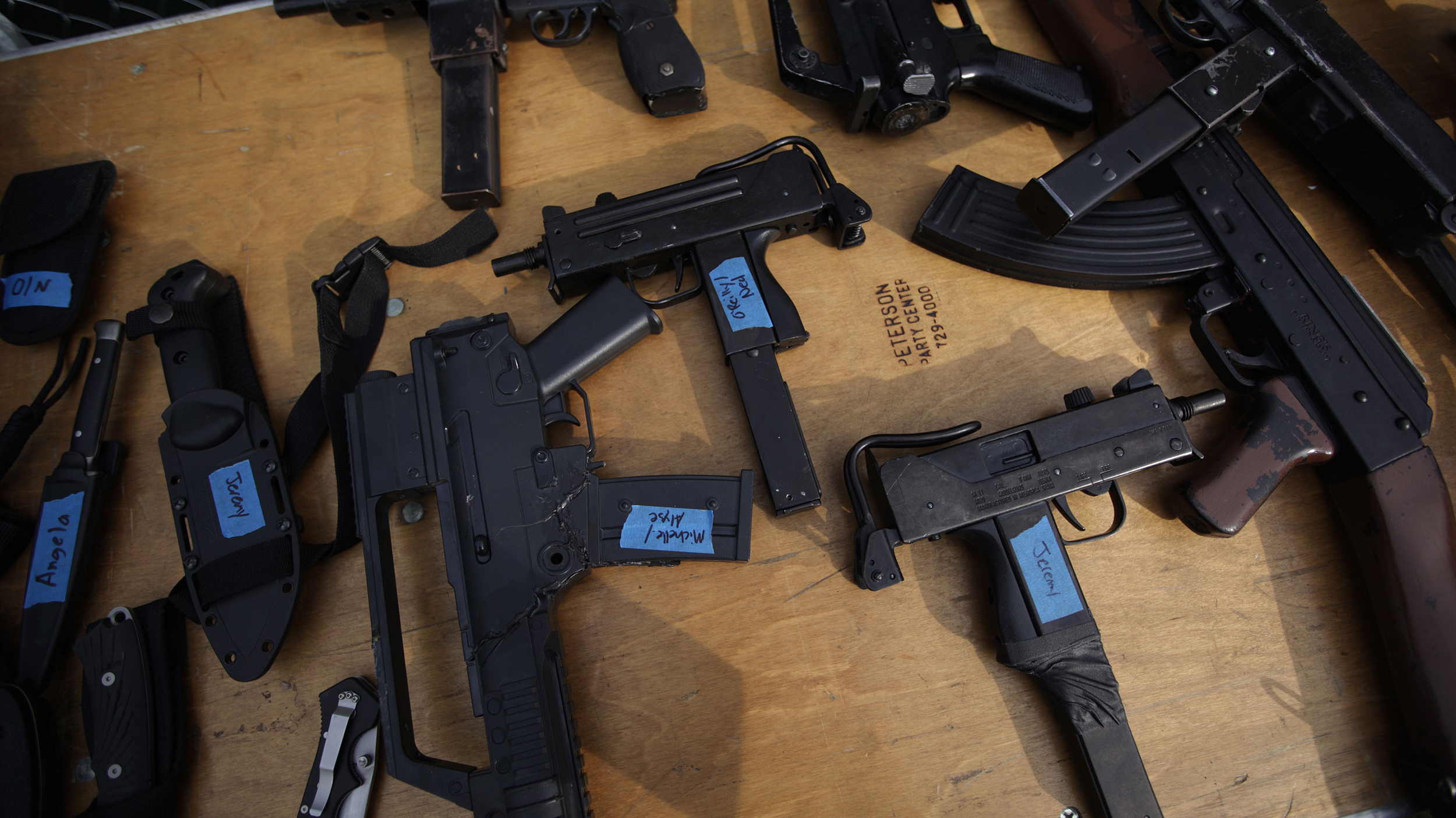 Gun props for a production of Coriolanus lie on a table backstage during rehearsal for the Commonwealth Shakespeare production of the play on Boston Common. 