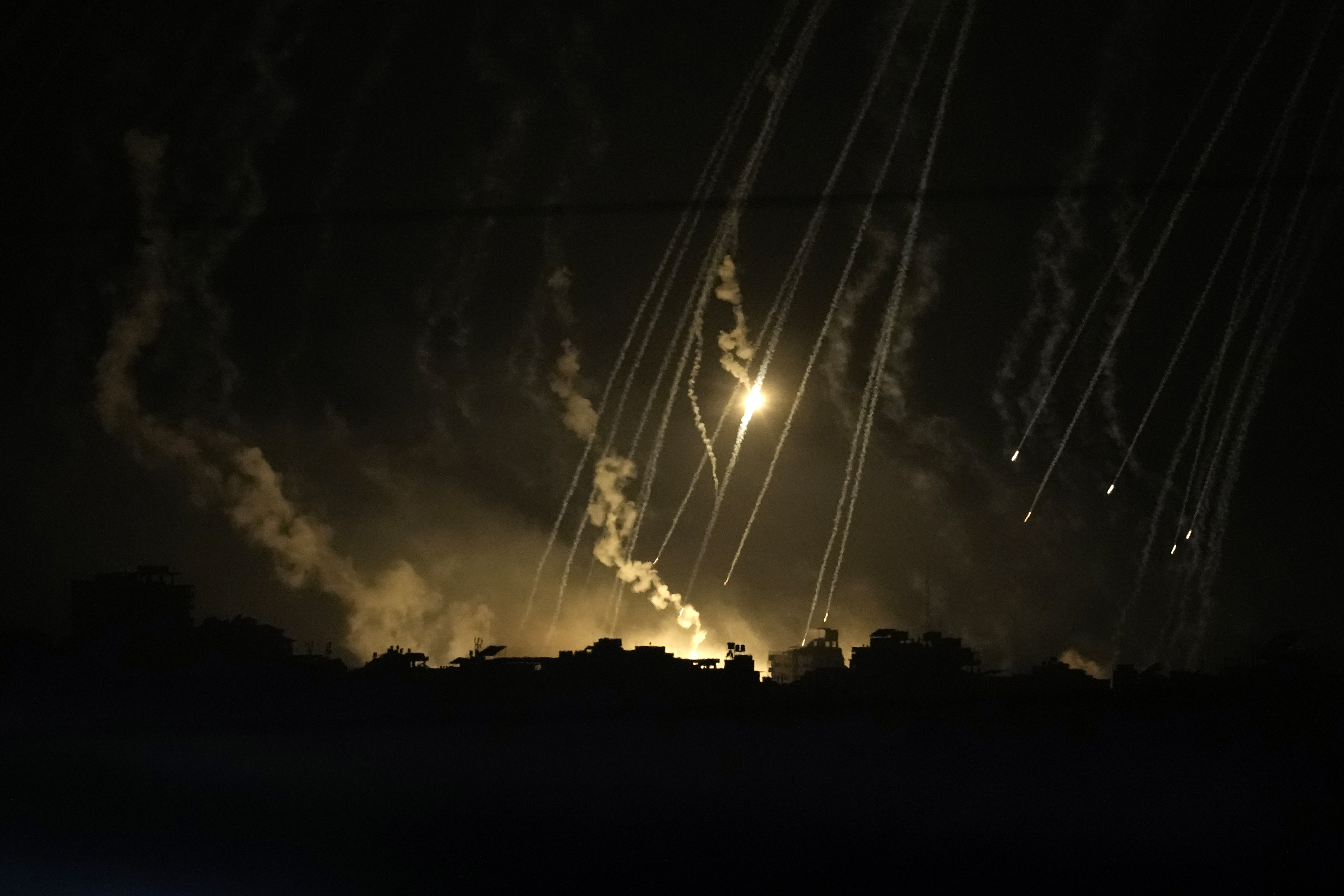 Smoke and flares rise during an Israeli strike in the Gaza Strip, as seen from southern Israel, Friday Nov. 10, 2023. (AP Photo/Leo Correa)