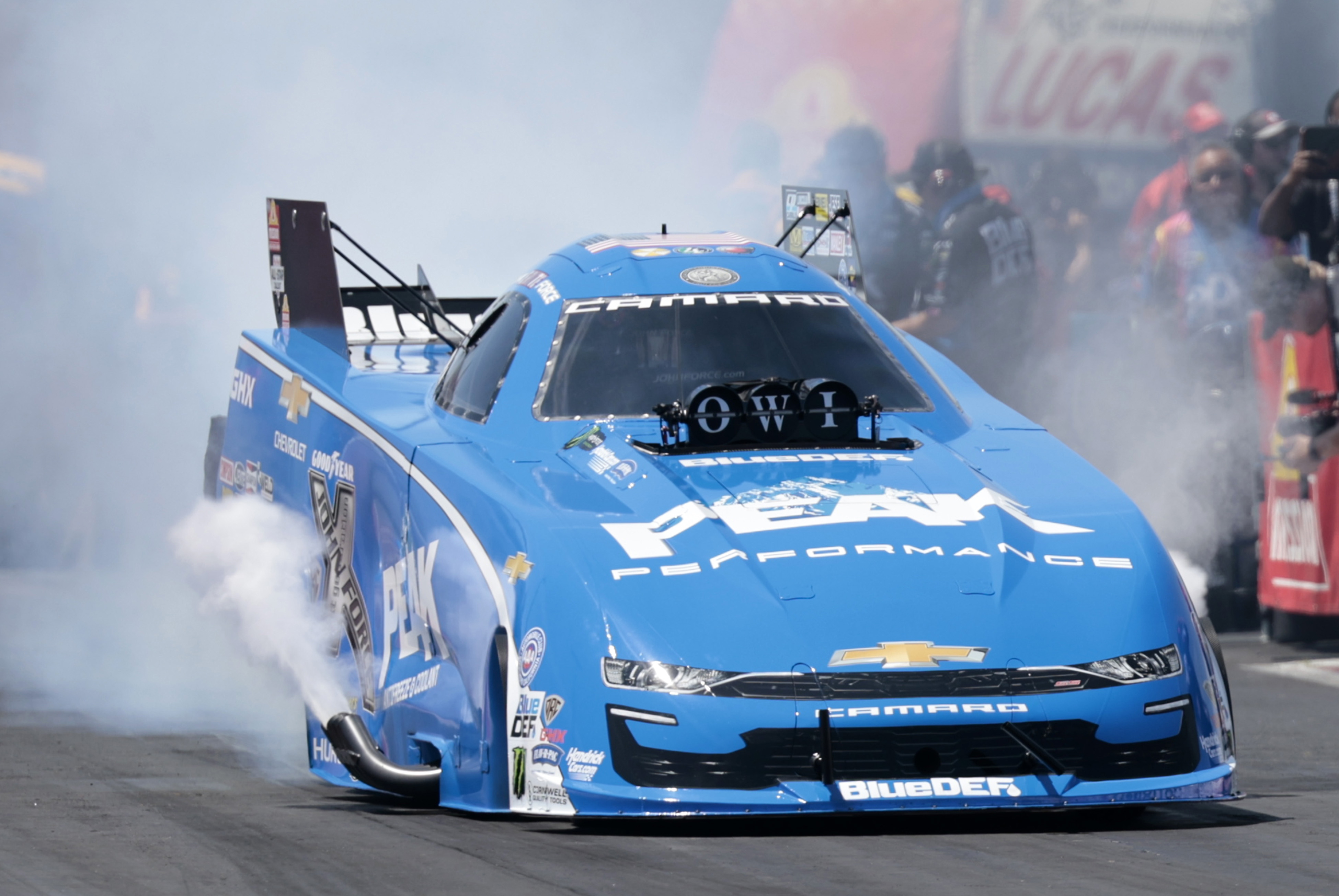 John Force, of Yorba Linda, CA, driving a JFR 500 Peak Chevy '22 Camaro SS smokes the tires in Fuel Funny Car qualifying during the NHRA New England Nationals on June 2, 2024, at New England Dragway in Epping, New Hampshire. (Photo by Fred Kfoury III/Icon Sportswire via Getty Images)