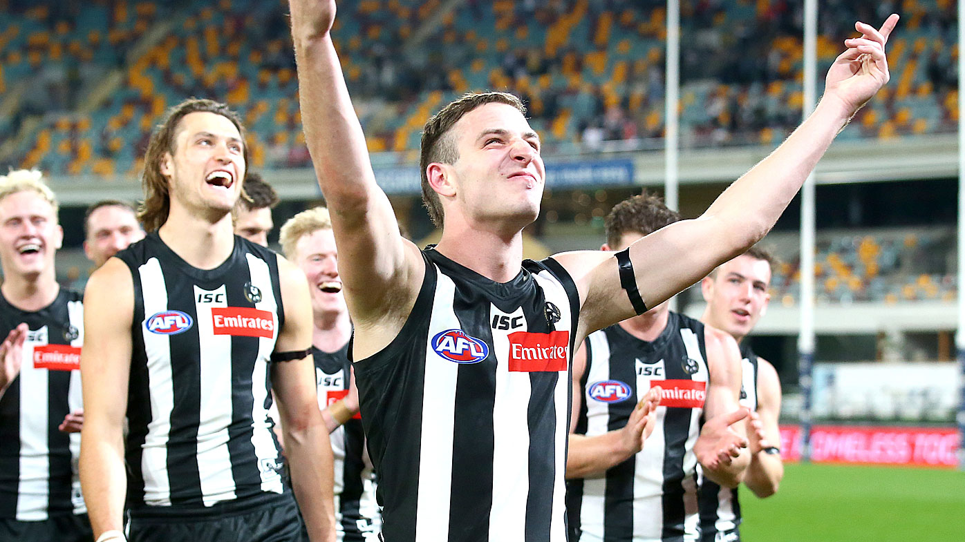 Trey Ruscoe of the Magpies celebrates the win with teammates