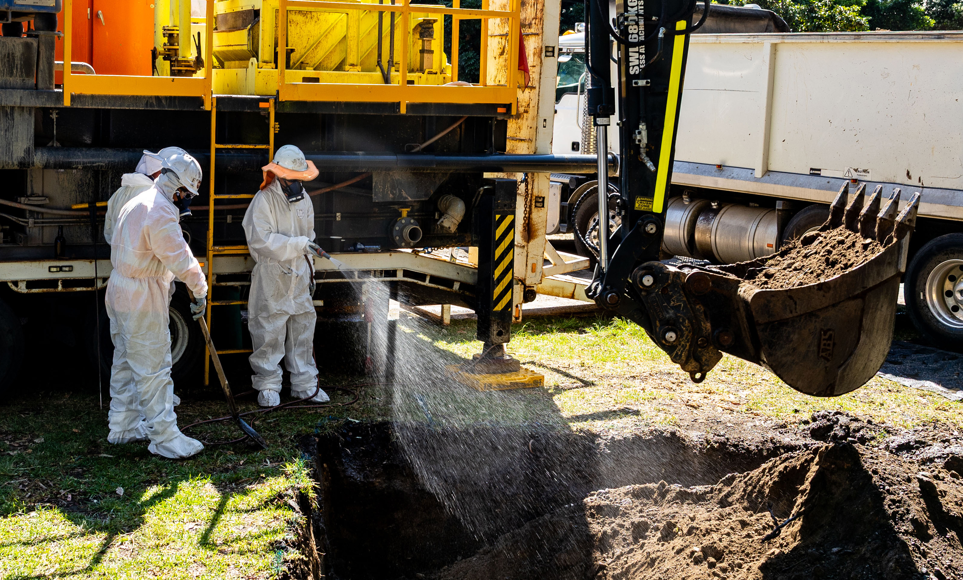 Cleanup workers are seen undertaking maintenance on a sewage pipe in Wentworth Park.