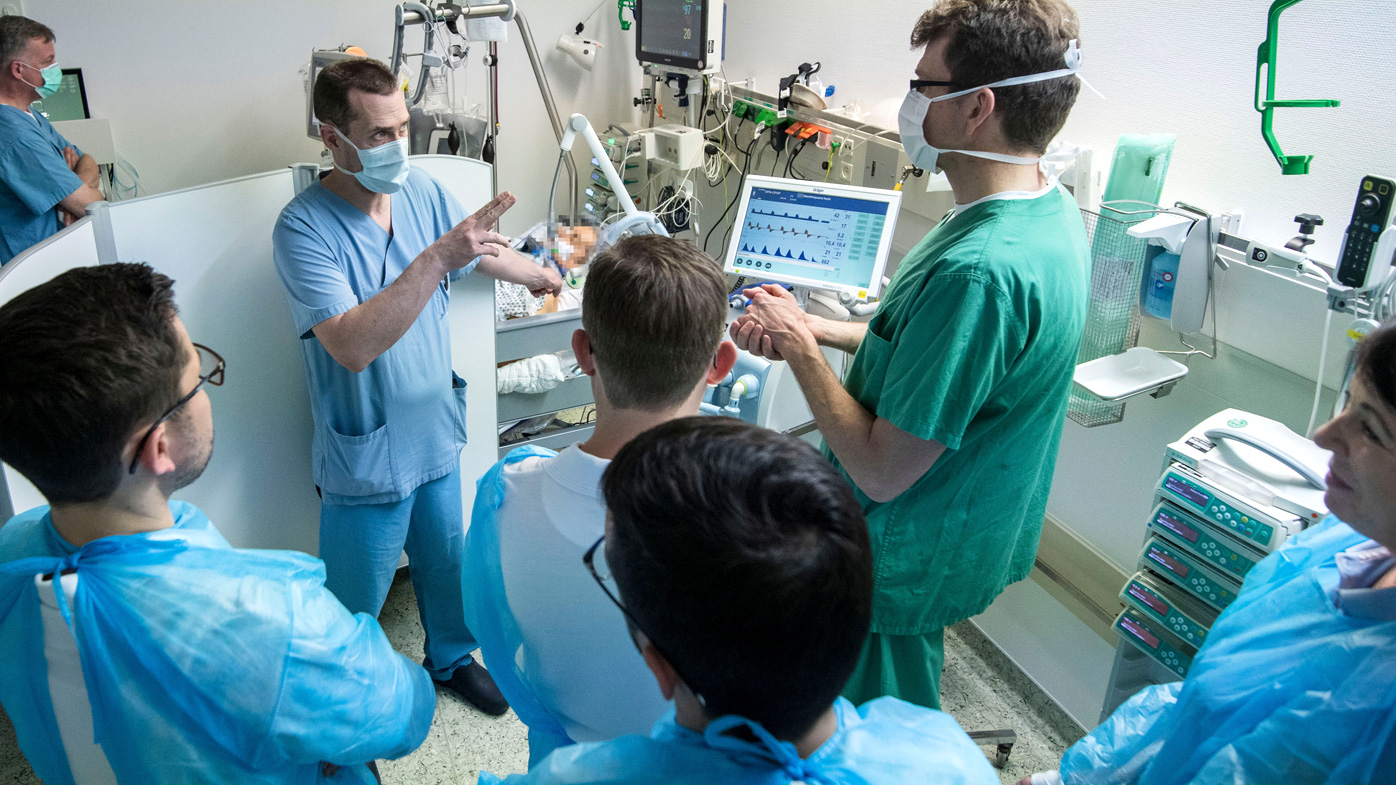 German doctors discuss a COVID-19 patient in an intensive care unit of the Klinikum Bad Hersfeld hospital.