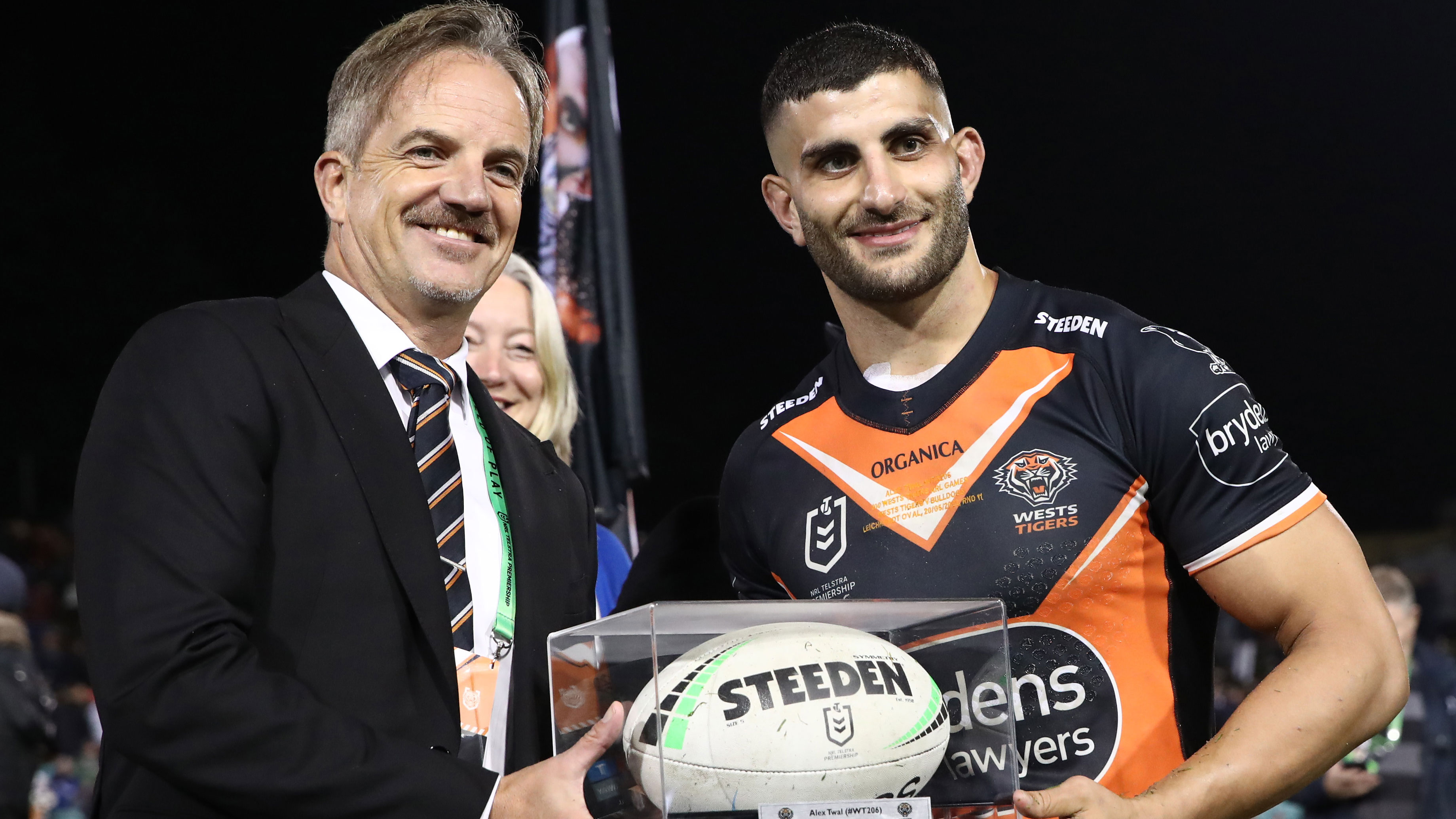 Tigers CEO Justin Pascoe presents Alex Twal the match ball after playing his 100th NRL game in May.
