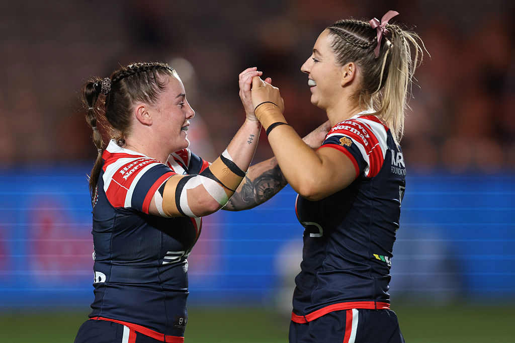 Jayme Fressard of the Roosters celebrates a try with Jocelyn Kelleher.