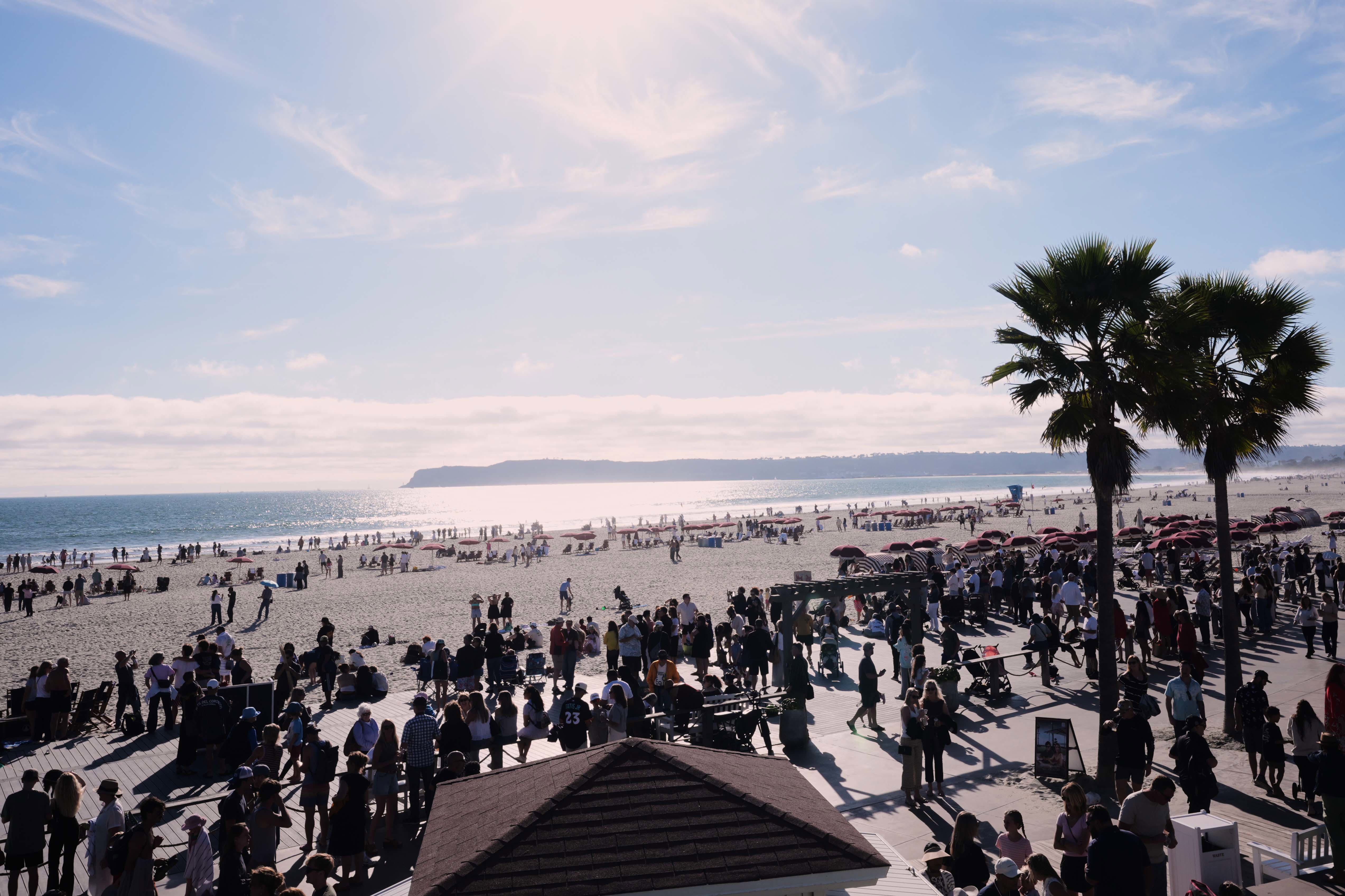 People wait for a glimpse of the return of NASA's Artemis II Friday, April 10, 2026, along the beach in Coronado, California.