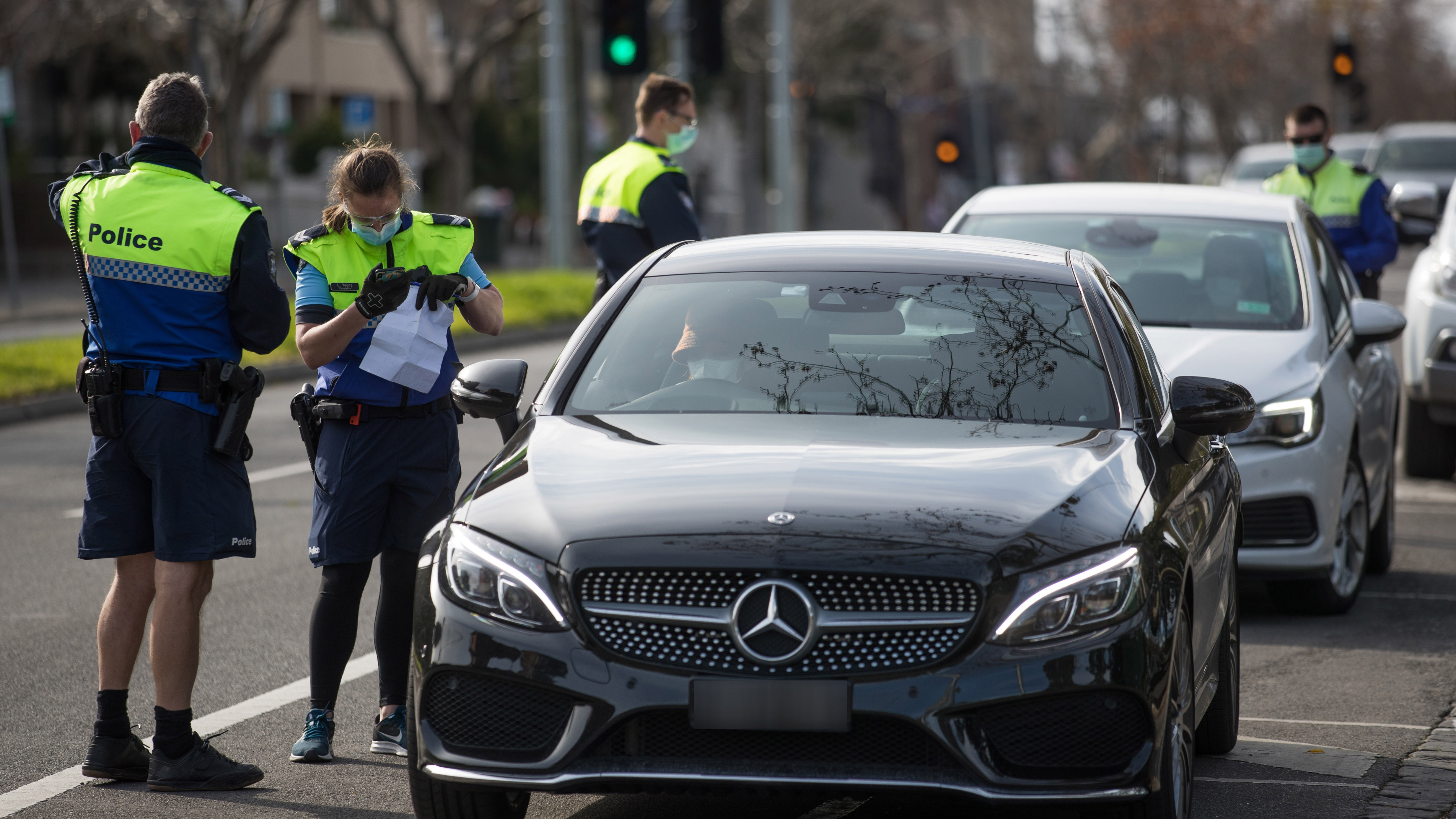 Police officers pulling over cars on Rathdowne street in Carlton, Melbourne.