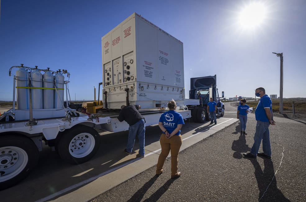 DART team members stand outside Astrotech Space Operations processing facility with the shipment container holding the DART spacecraft. DART moved to SpaceX's payload processing facility late October.