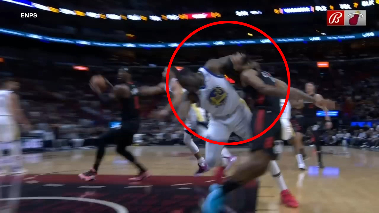 Draymond Green drags Patty Mills (right) by the neck.