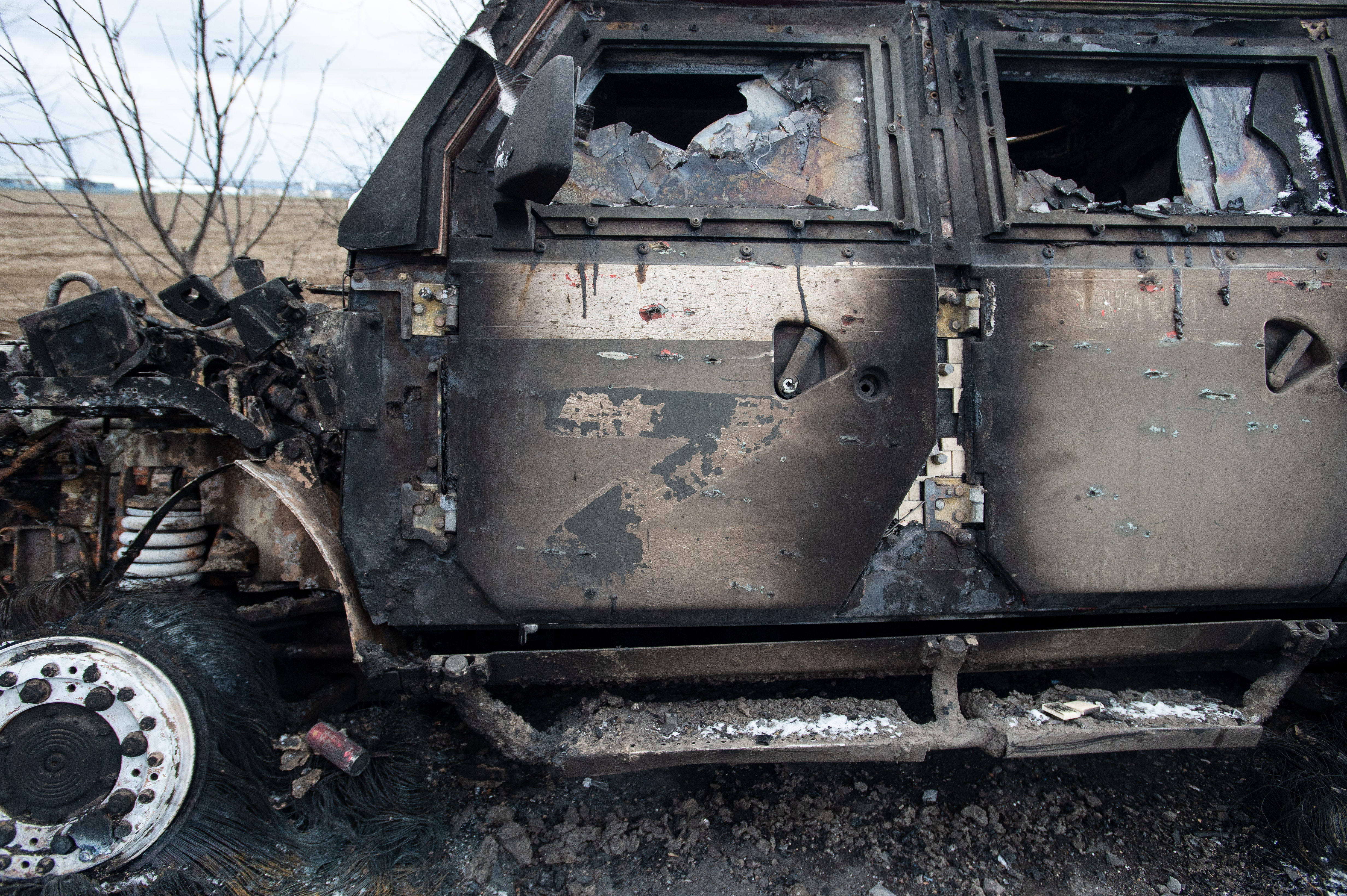 MYKOLAIV, UKRAINE - MARCH 10:  A burnt out Russian Tigr fighting vehicle sits long a road, the Z letter on the door denoting its Russian origin as Ukraine Army troops dig in at frontline trench positions to continue repelling Russian attacks, east of the strategic port city of Mykolaiv, Ukraine, on March 10, 2022. Ukrainian forces have fended off several concerted ground attacks, with Russian forces coming northwest from Crimea and via Kherson, and filing frequent missile and rockets strikes on 