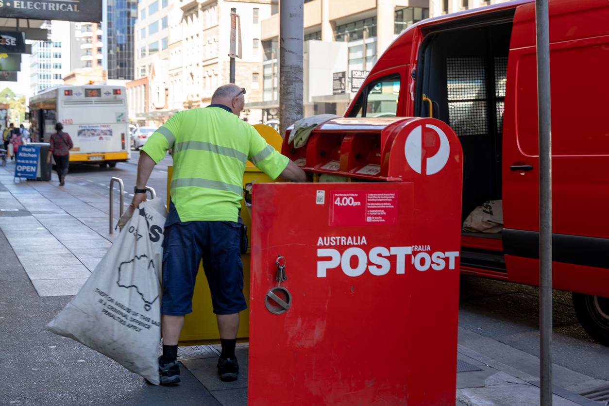 Adelaide, Australia - 18 Feb 2021: A Australia Post postmen is collecting the post from the mail box.