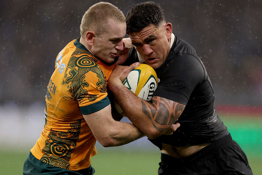 Codie Taylor of the All Blacks is tackled by Max Jorgensen of the Wallabies.