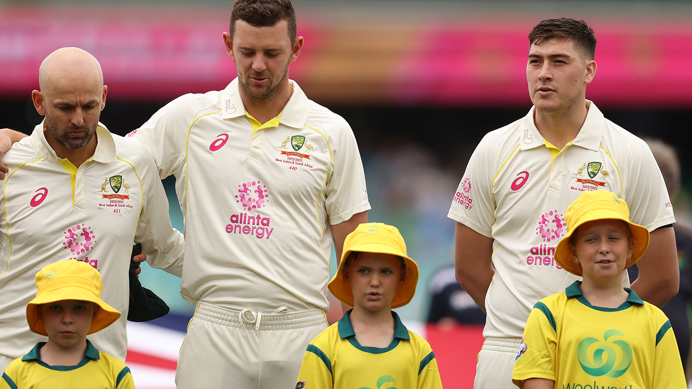 Matt Renshaw (right) stands apart from the rest of the team at the national anthem.