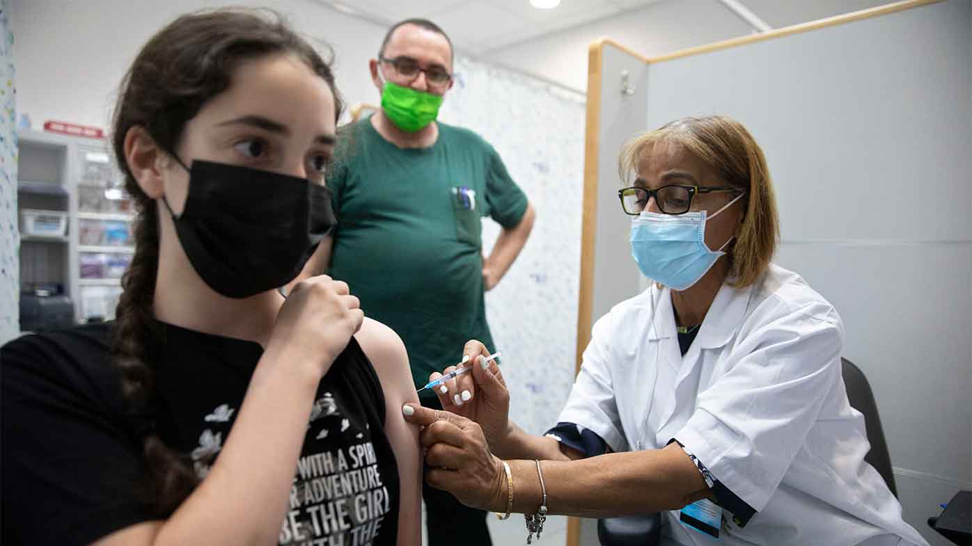 An Israeli youth receives a Pfizer-BioNTech COVID-19 vaccine in the central Israeli city of Rishon LeZion.