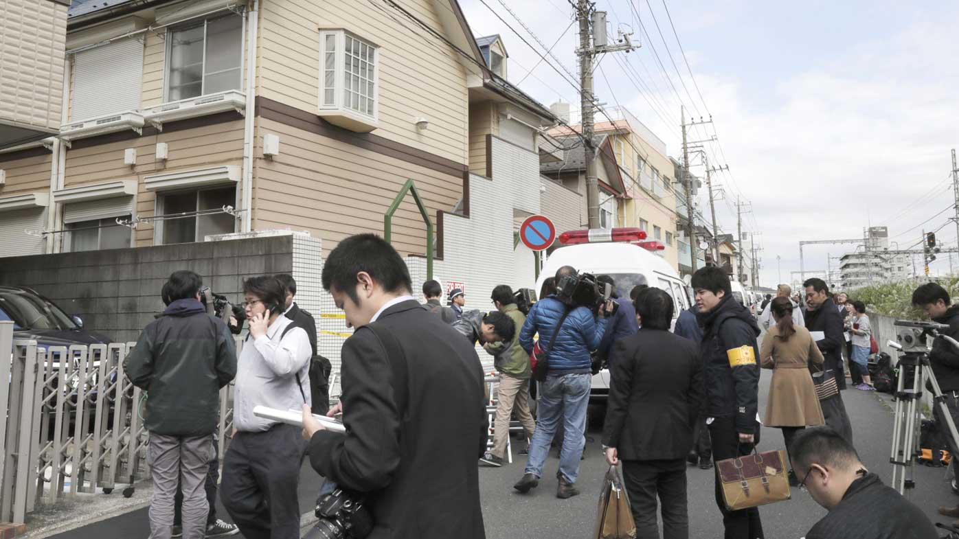 A crowd outside the apartment where Takahiro Shiraishi killed nine people.