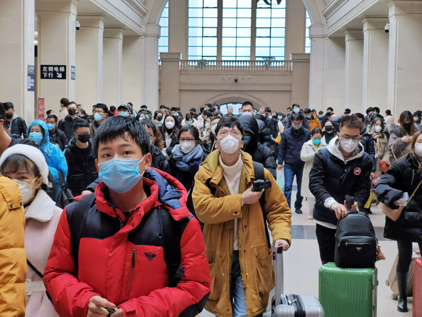 People wear face masks as they wait at Hankou Railway Station on January 22, 2020 in Wuhan, China. 