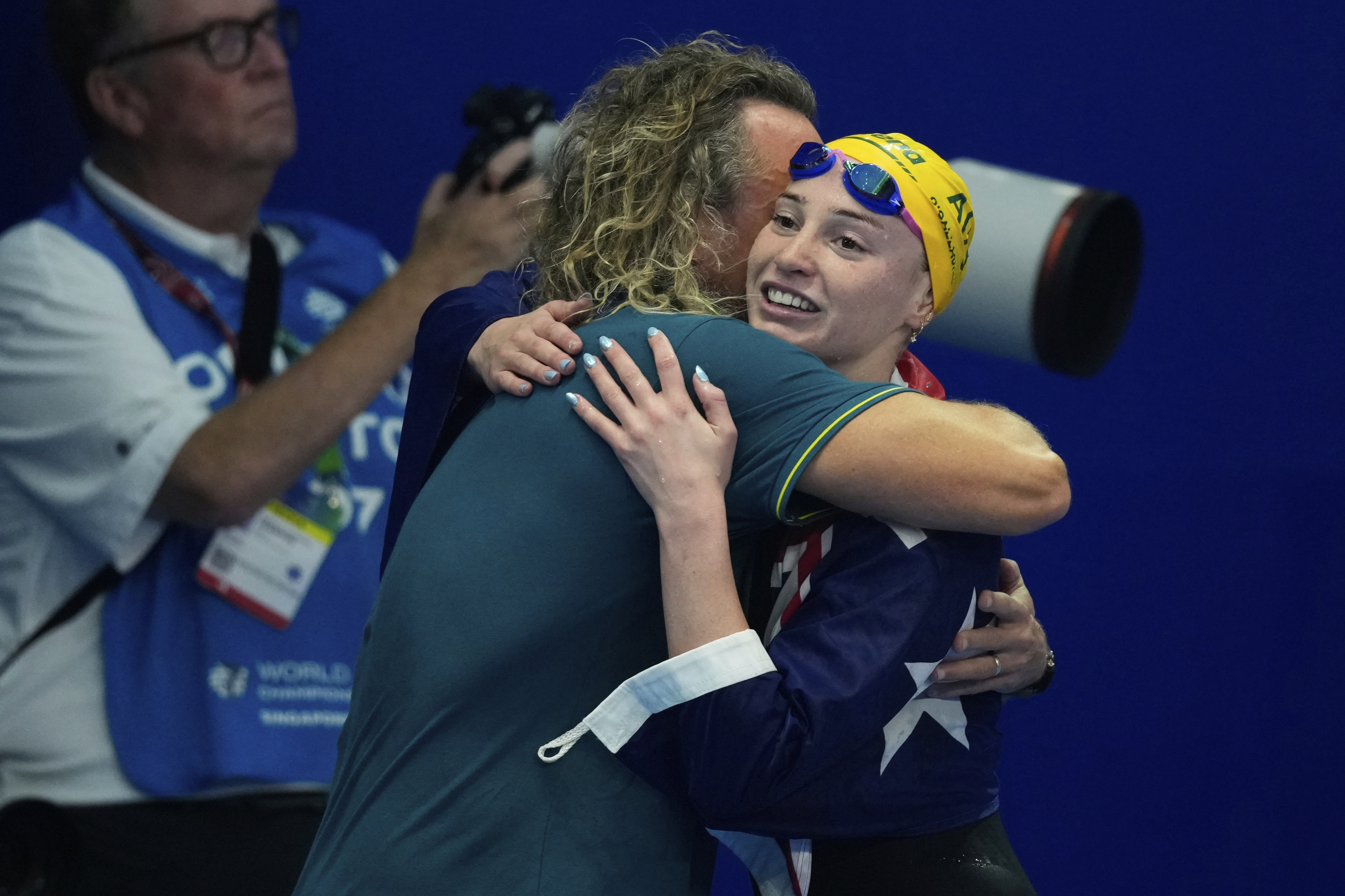 Mollie O'Callaghan and her coach, Dean Boxall, share a warm embrace after her triumph.