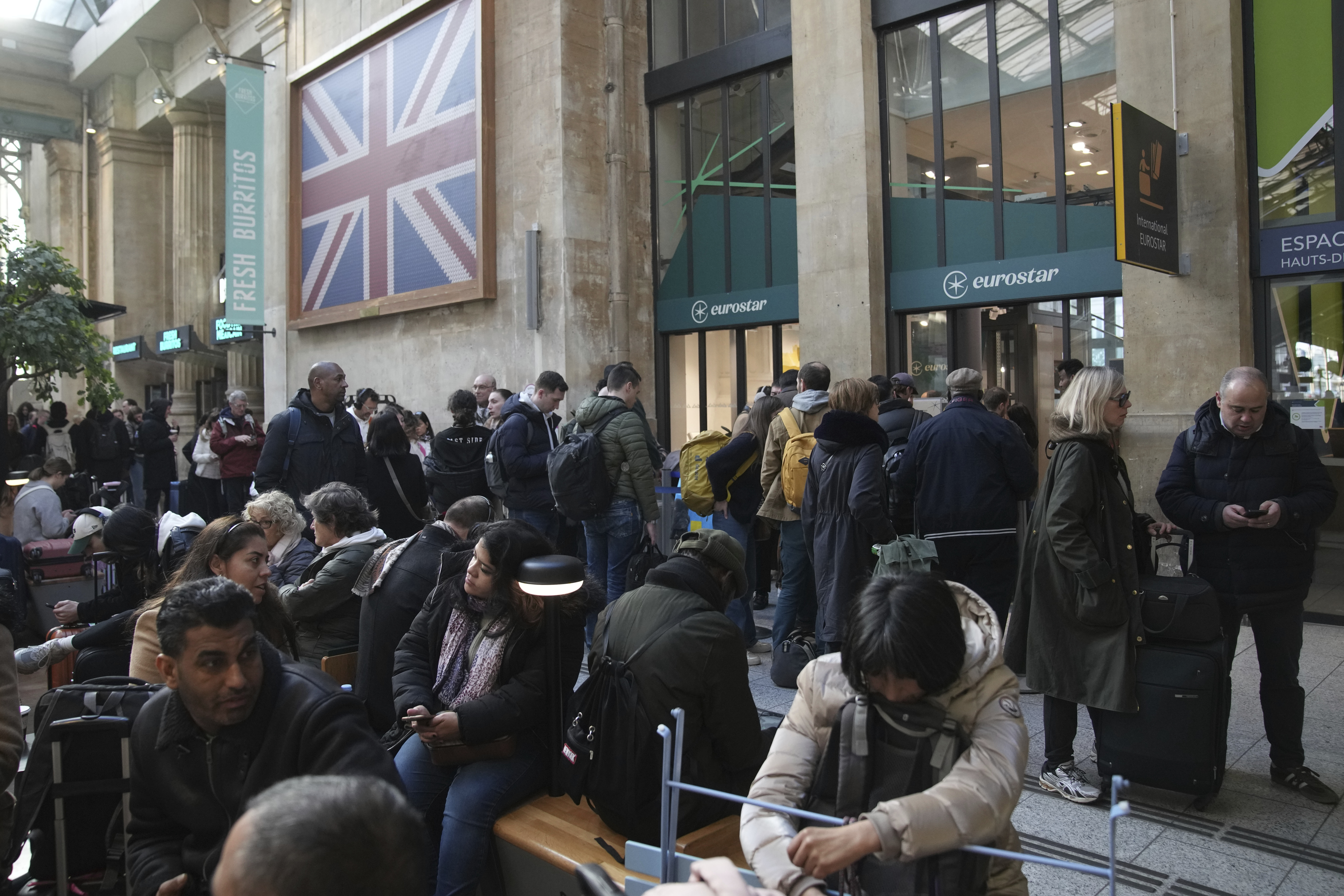 Passengers wait as Eurostar trains to London and all trains heading to northern France have been brought to a halt