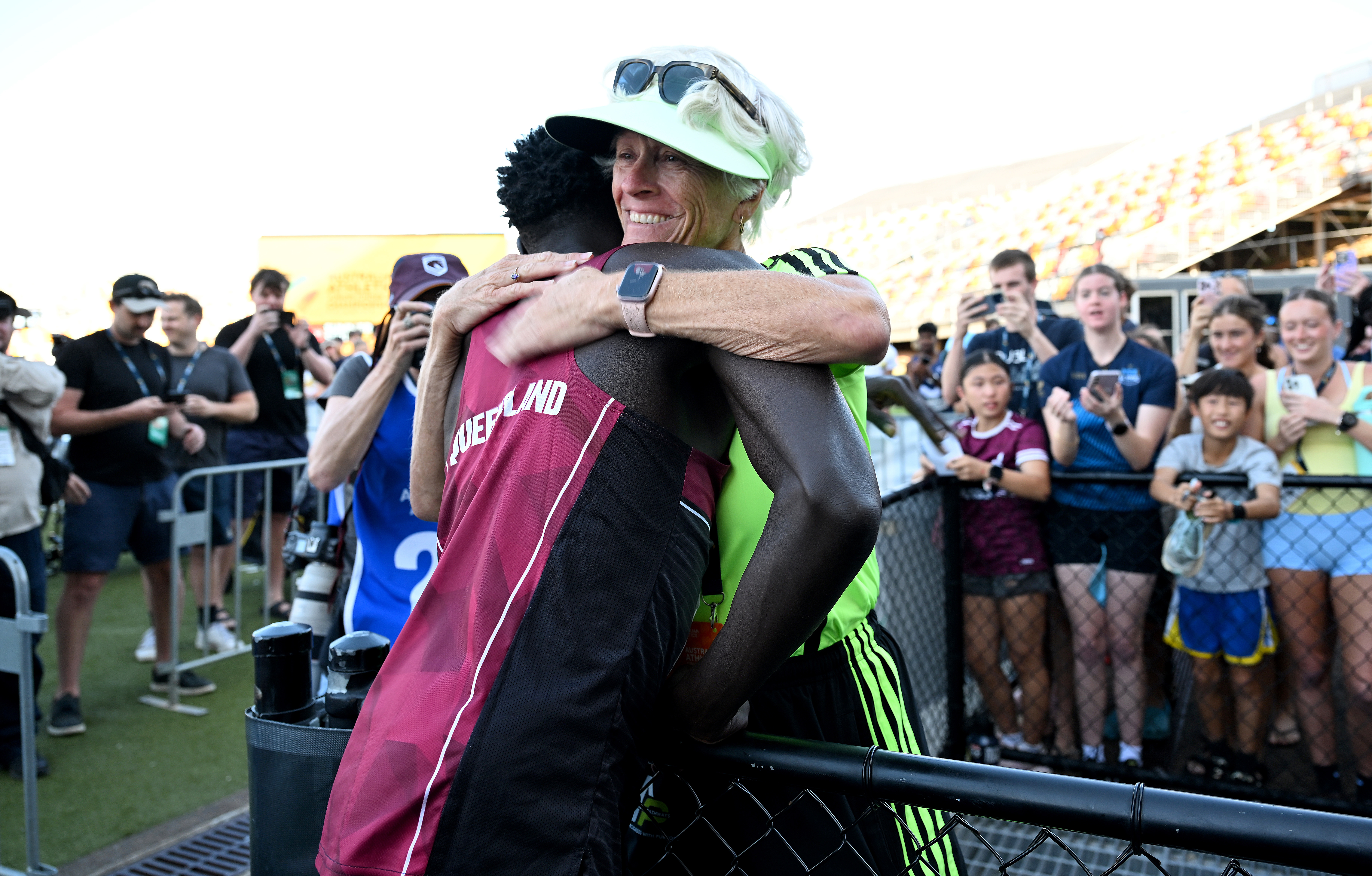 BRISBANE, AUSTRALIA - APRIL 18: Gout Gout embraces his coach Di Sheppard after winning the final of the Men's U20's 100m event during the 2026 Australian Athletics Junior Championships at Queensland Sport and Athletics Centre on April 18, 2026 in Brisbane, Australia. (Photo by Bradley Kanaris/Getty Images)