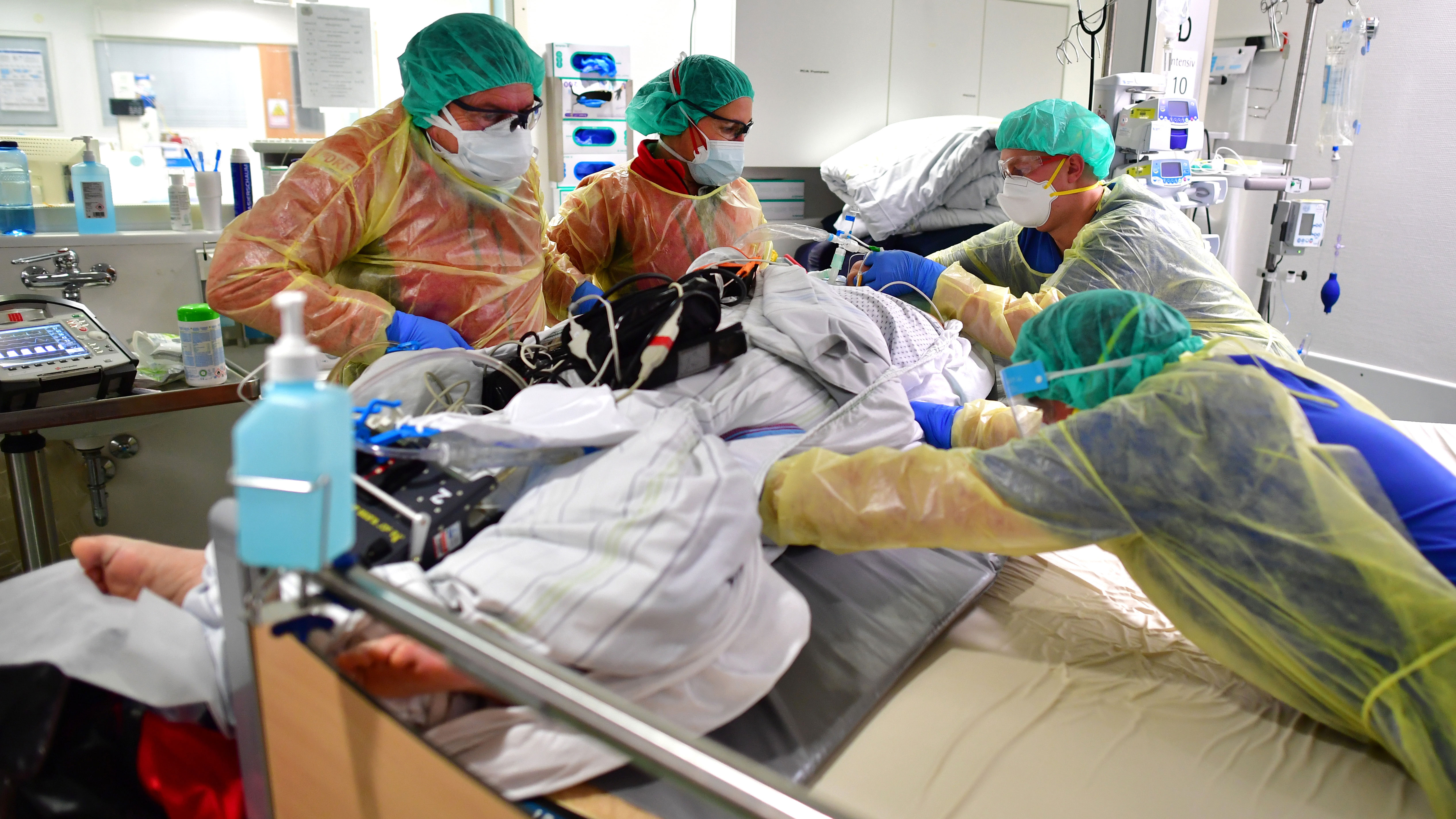 A German doctor and team prepare a COVID-19 patient for transfer from one COVID-19 intensive care unit for transport by helicopter to another hospital during the fourth wave of the coronavirus pandemic in Nuremberg.