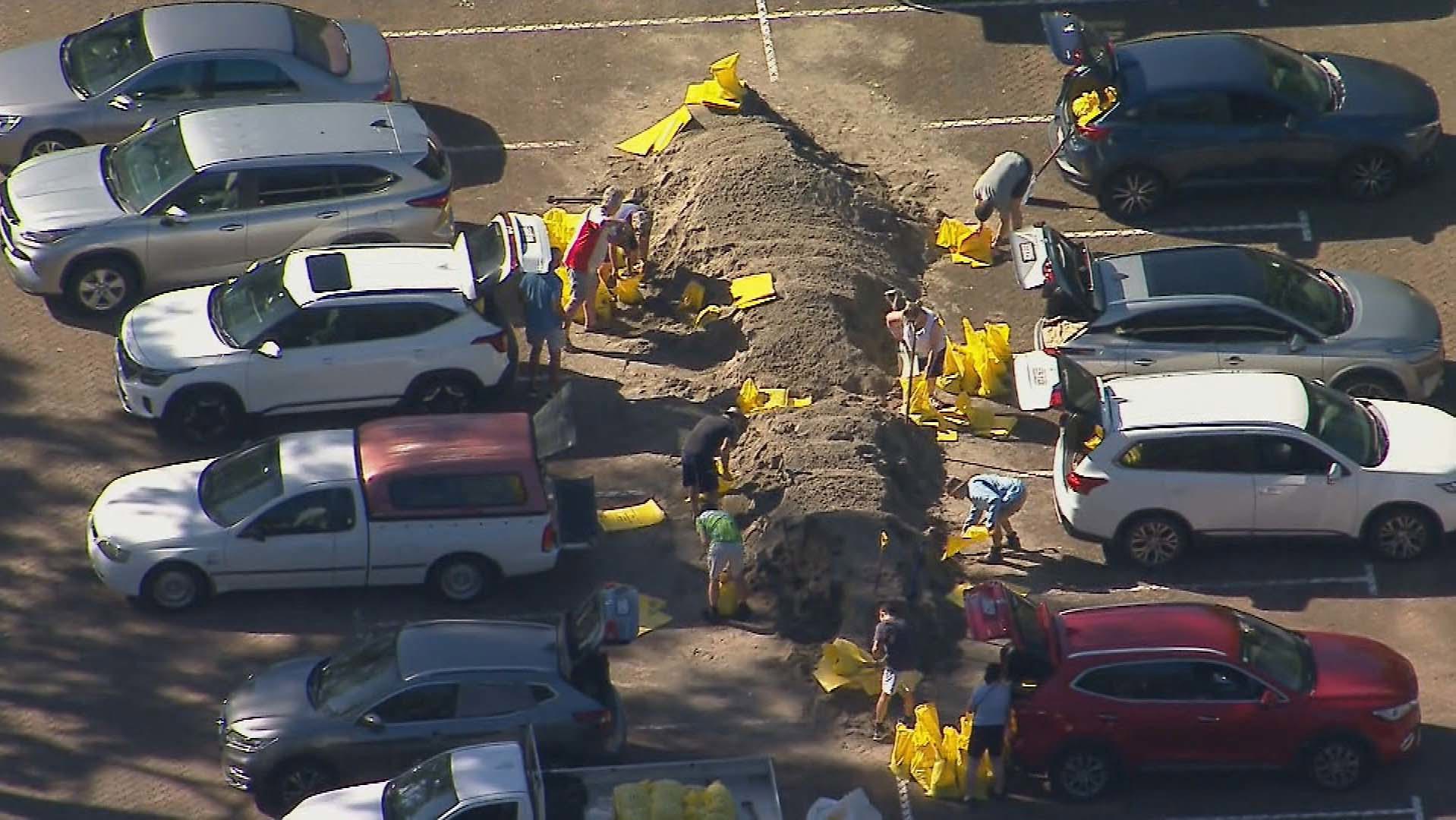 Locals in Queensland get themselves sandbags to prepare from the flooding forecast to hit Brisbane, the Gold Coast and northern NSW from the cyclone.