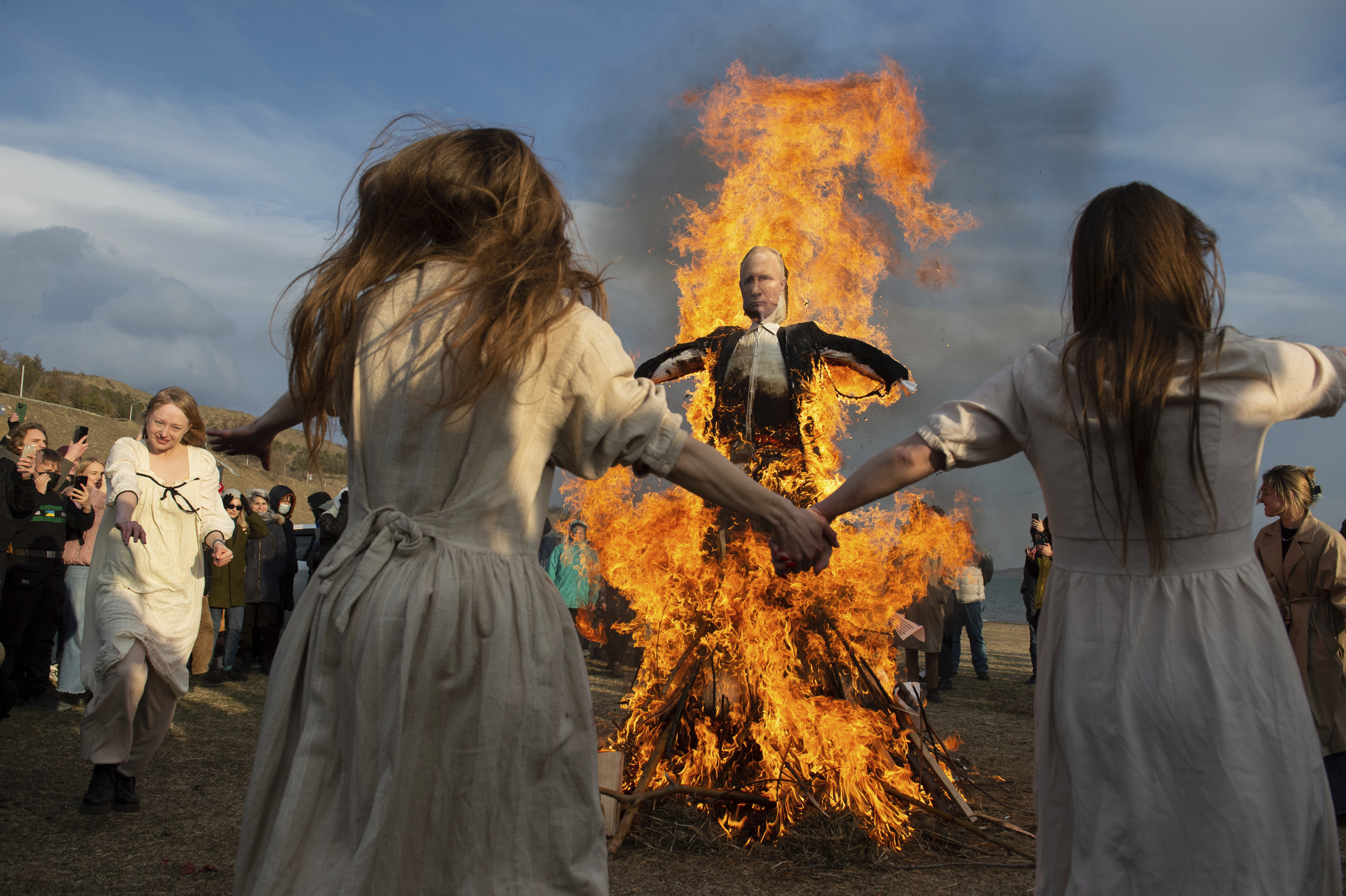 Demonstrators dance around a burning effigy of the Russian President Vladimir Putin during an anti-war action in Tbilisi, Georgia. 
