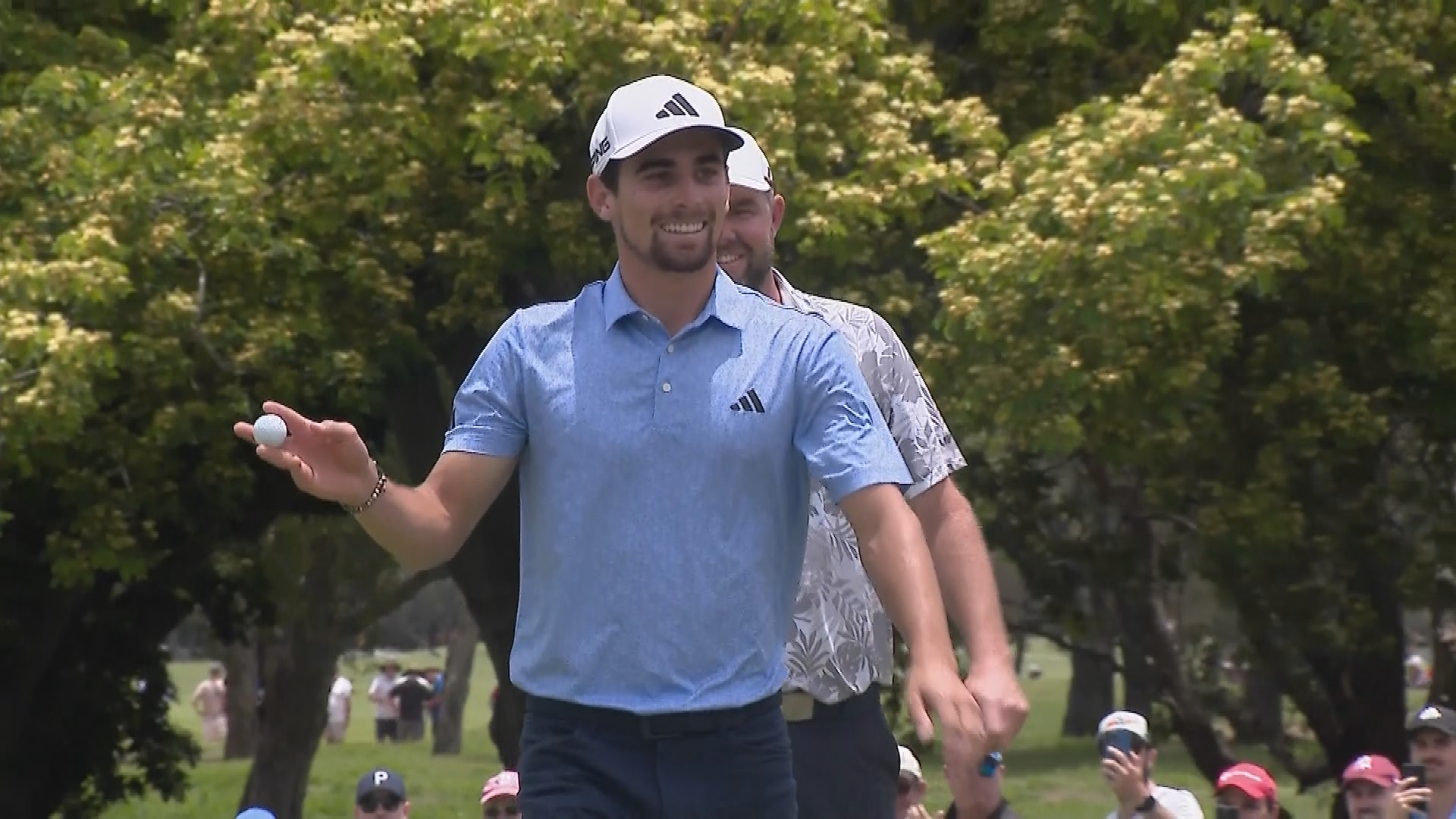 Joaquin Niemann acknowledges the  crowd after hitting a hole in one on the par-3 fourth hole during the final round of the Australian PGA Championship at Royal Queensland.