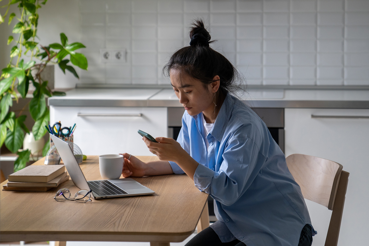 Woman chesk social media on her phone before starting work