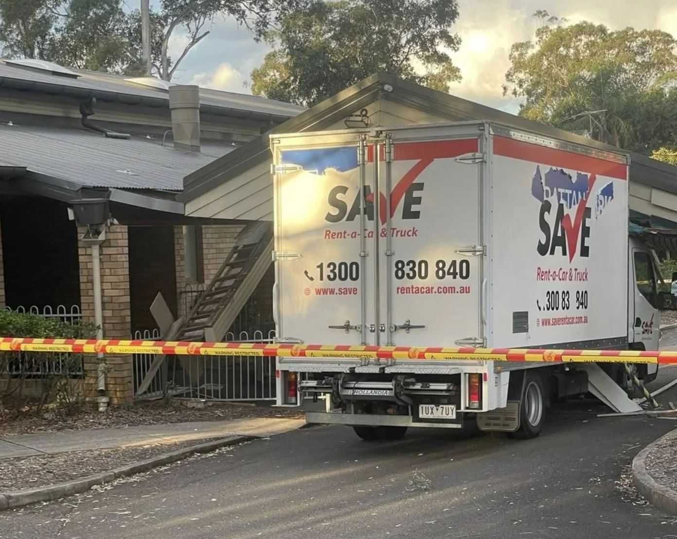 A van carrying branding for Liberal candidate for Greenway, Rattan Virk, wedged underneath the entrance to the Quakers Hill Community Centre on Monday April 21.