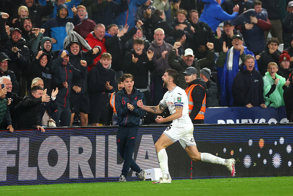 Cameron Burgess of Swansea City celebrates scoring his team's third goal.