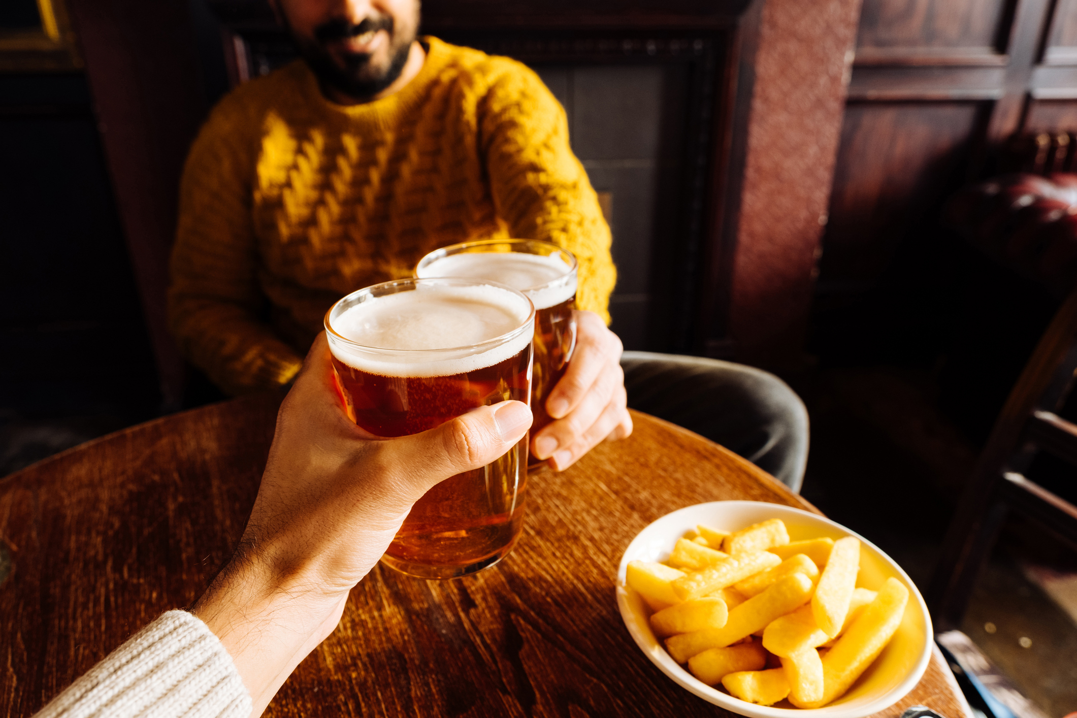 People drinking beer at pub stock image