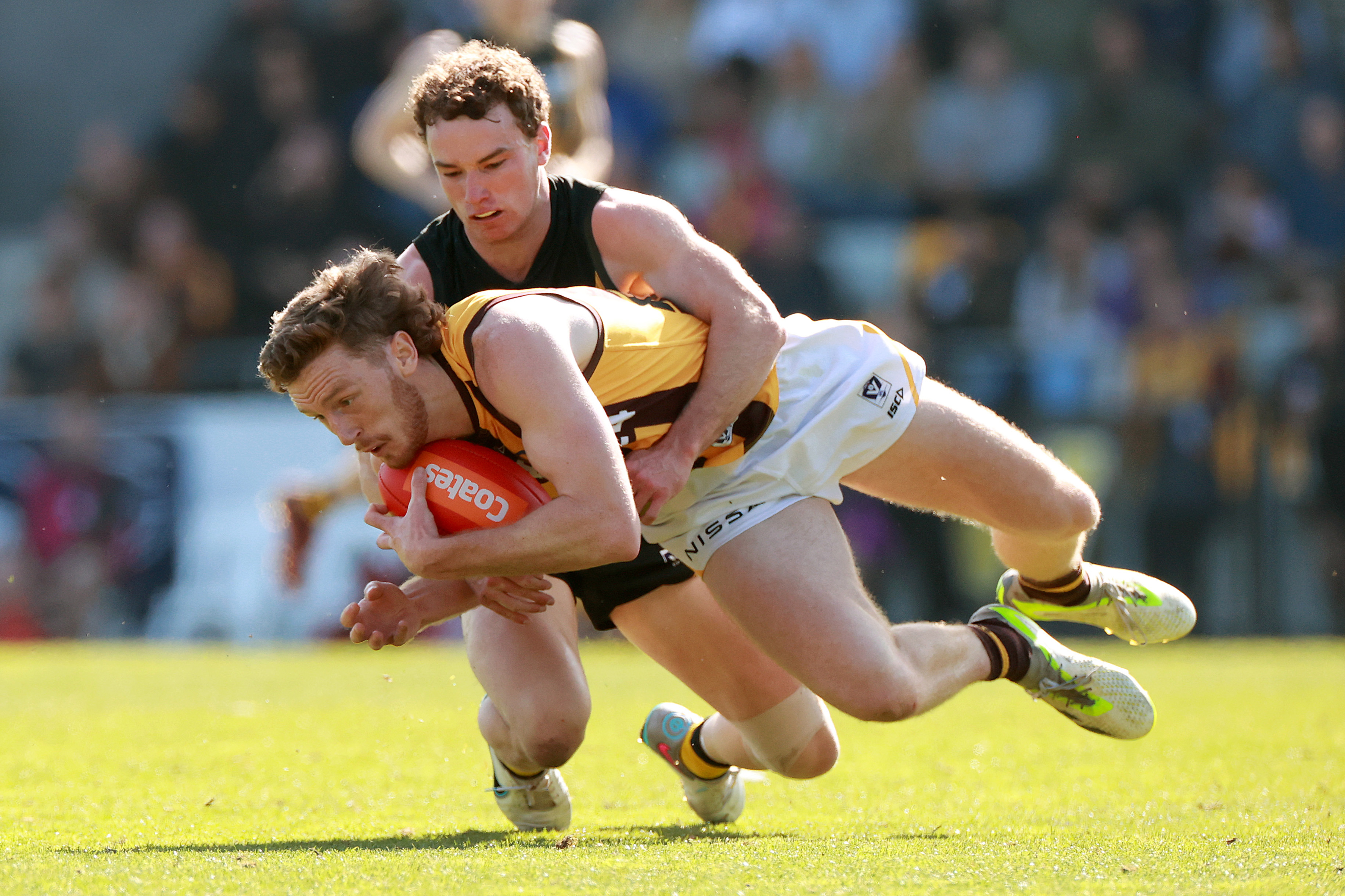 Denver Grainger-Barras of the Hawks is tackled by Jack Henderson of Werribee.