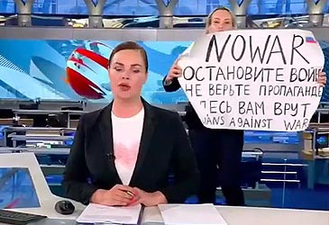 Marina Ovsyannikova holding protest sign behind Russian newsreader (supplied)