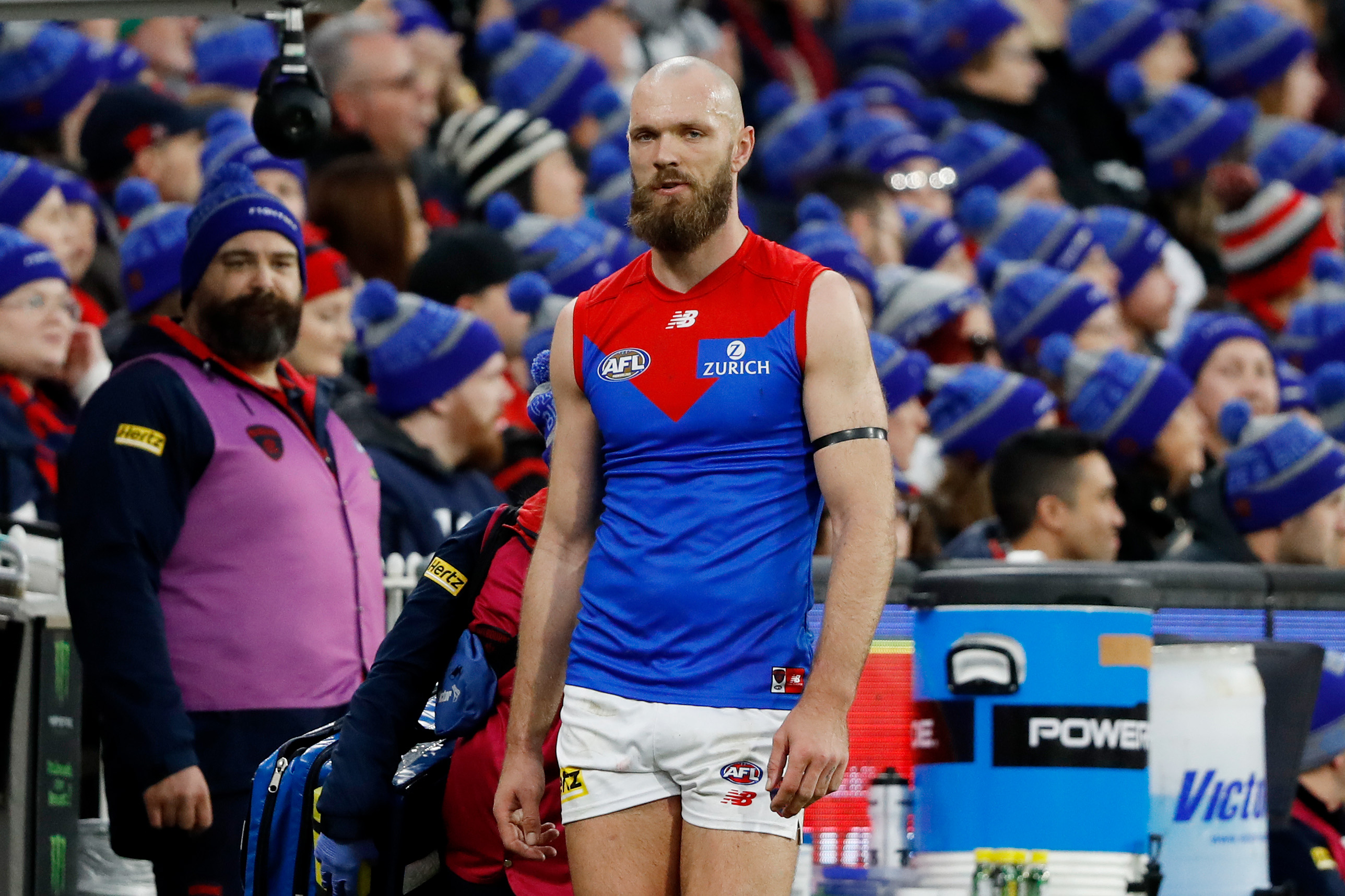 Melbourne's Max Gawn comes to the bench injured.