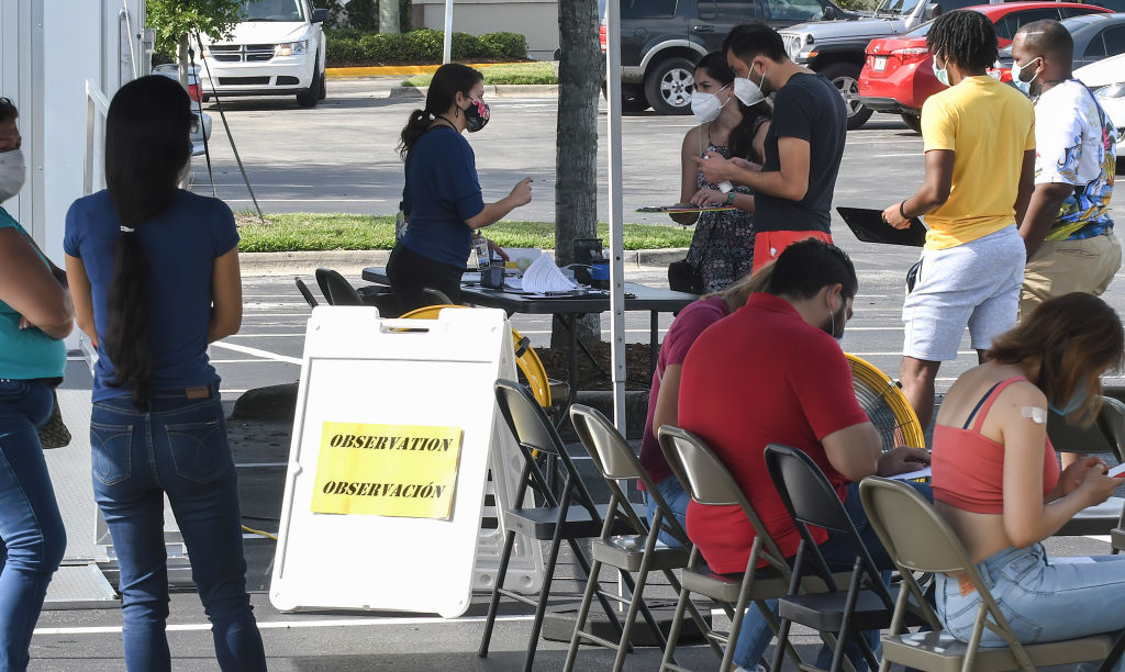 People register to receive a COVID-19 vaccine shot at a mobile vaccination site in Orlando, Florida.