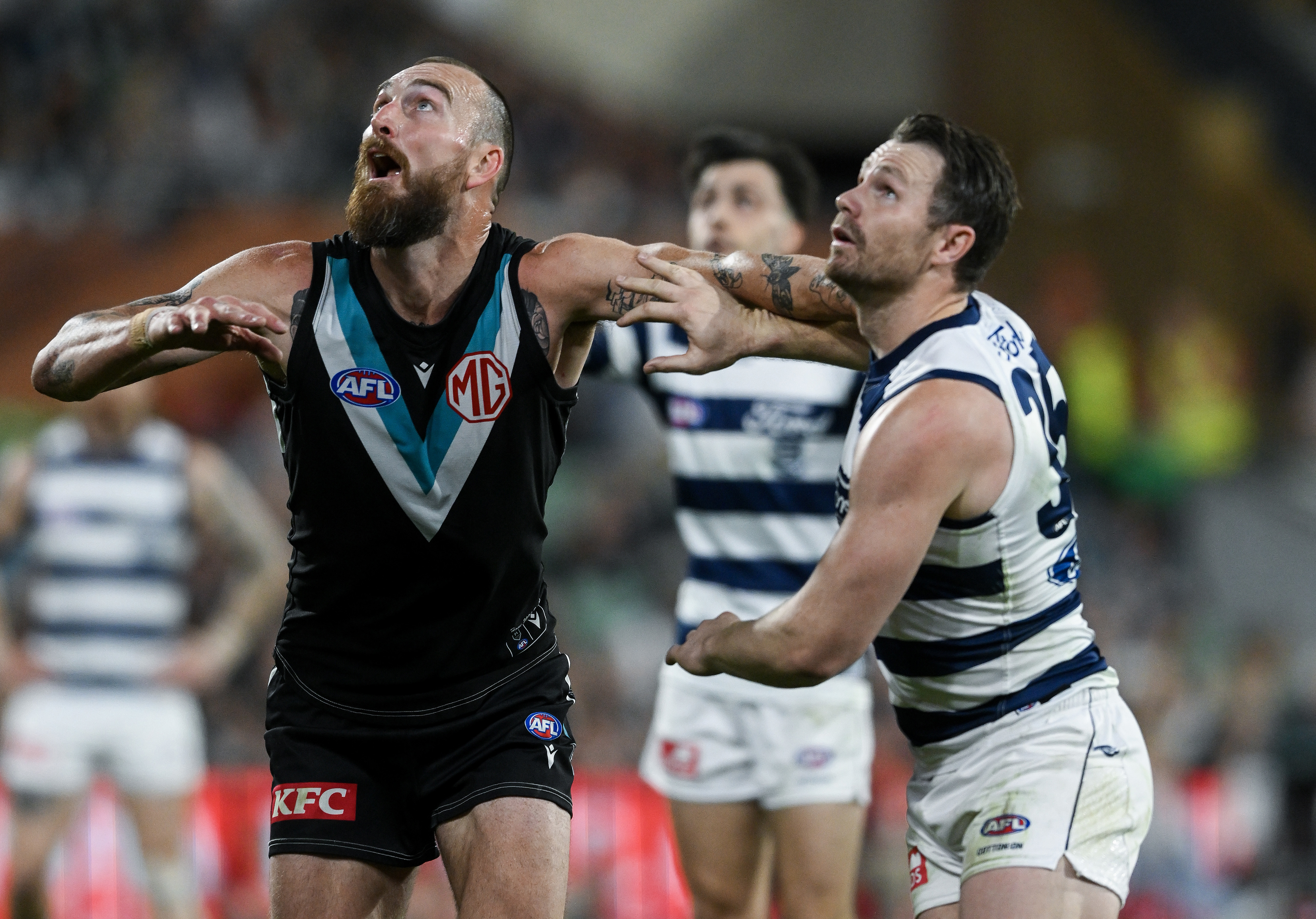 Charlie Dixon of the Power rucks against Patrick Dangerfield of the Cats in the qualifying final.