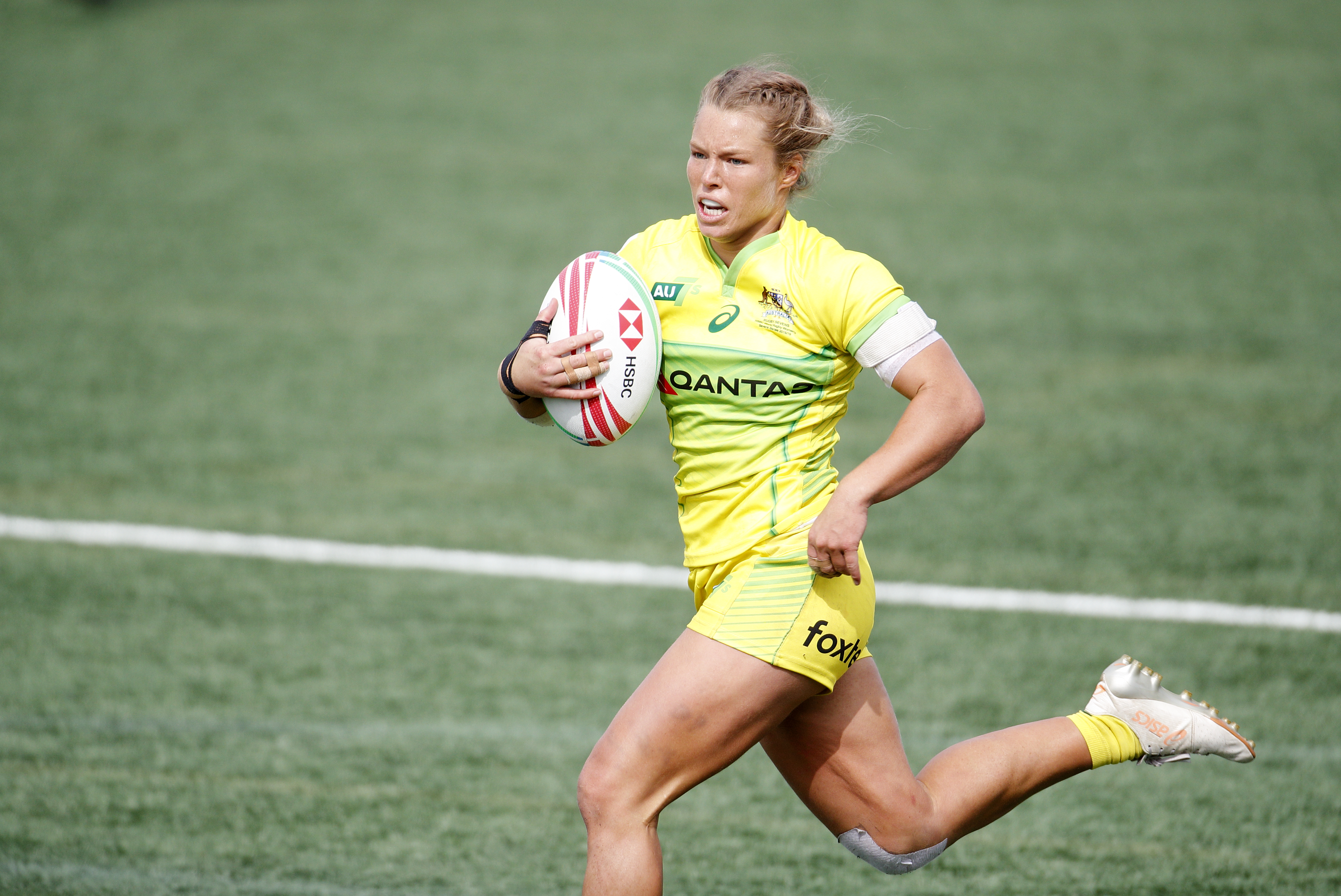 Australia's Emma Tonegato runs with the ball against New Zealand during the HSBC World Rugby Sevens Series Gold medal match.